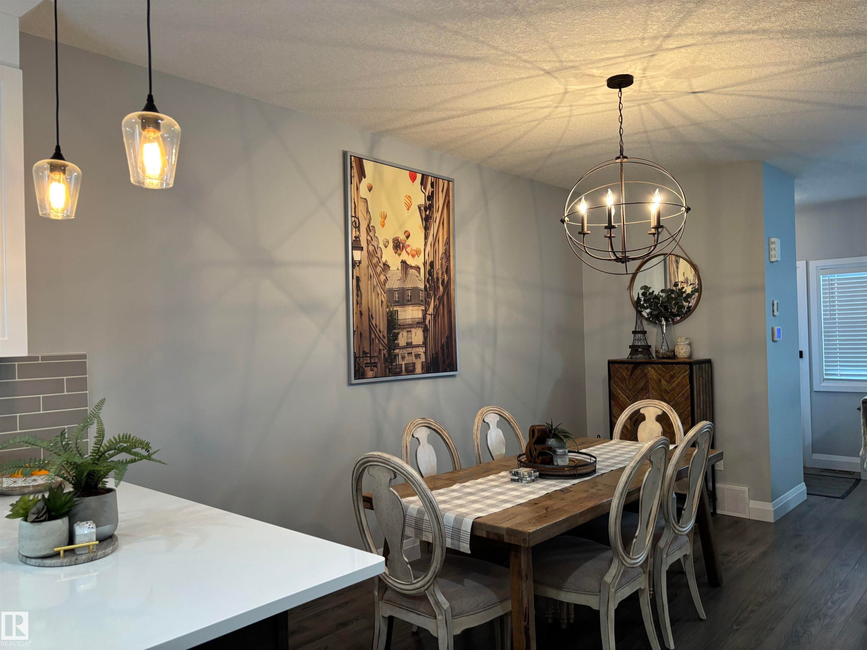 Dining area with dark wood-type flooring and a chandelier - 25 Harrison Gate, Spruce Grove, AB - Indoor Photo Showing Dining Room