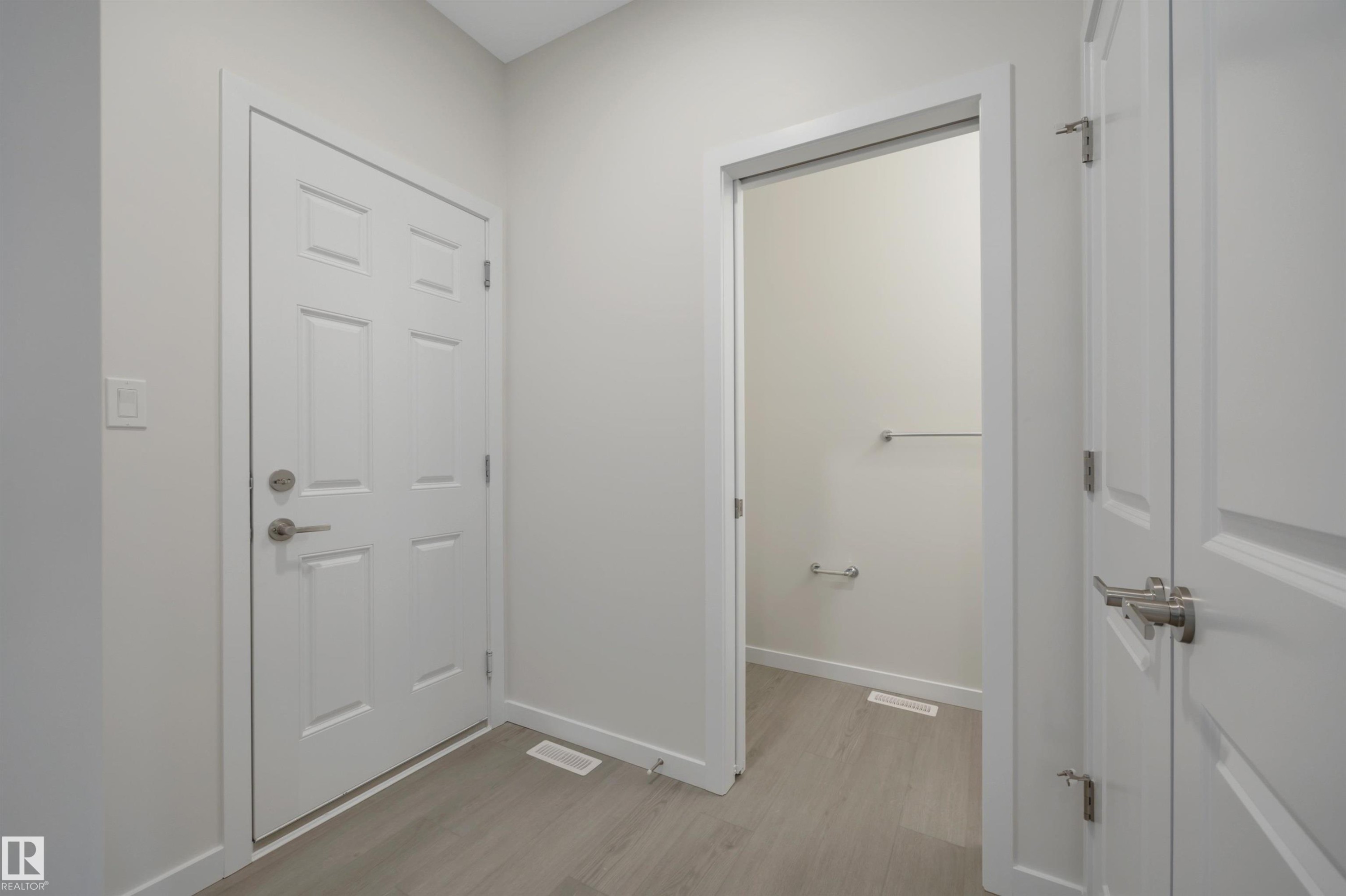 Doorway to outside featuring wood finished floors and baseboards - 5742 Hawthorn Common, Edmonton, AB - Indoor Photo Showing Other Room