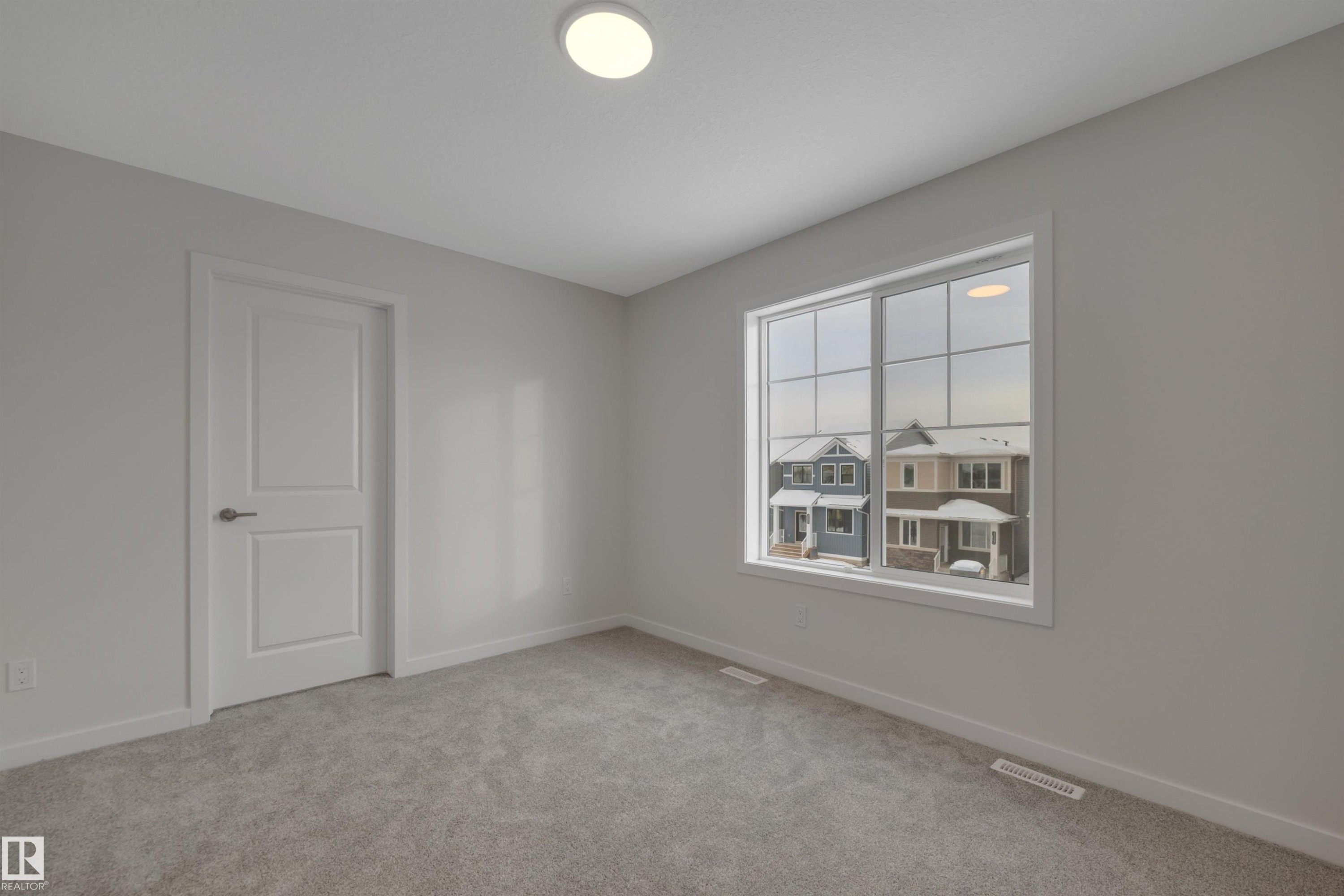 Spare room with baseboards and light carpet - 5742 Hawthorn Common, Edmonton, AB - Indoor Photo Showing Other Room