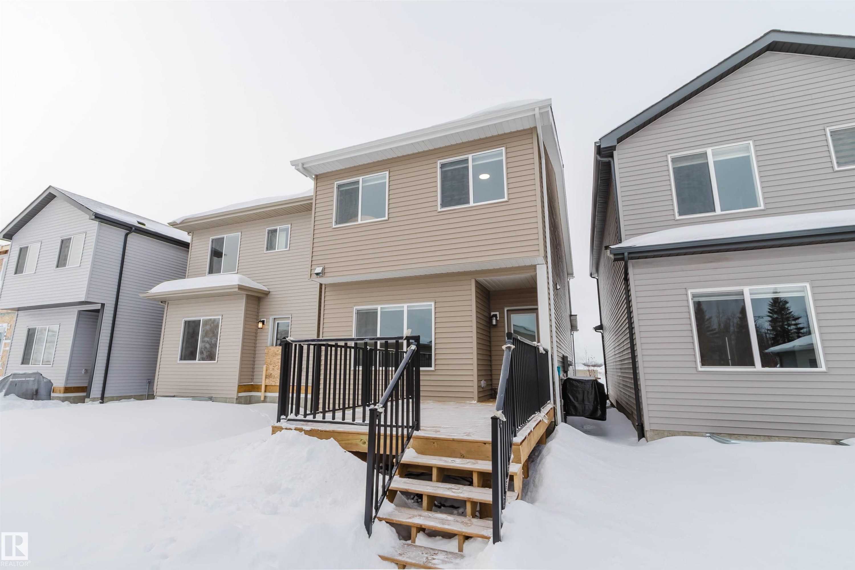Snow covered house featuring a wooden deck - 343 Edgemont Drive, Edmonton, AB - Outdoor