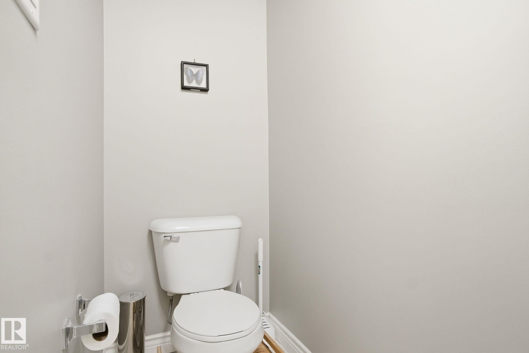 Bathroom featuring toilet and baseboards - 301 9603 98 Avenue, Edmonton, AB - Indoor Photo Showing Bathroom