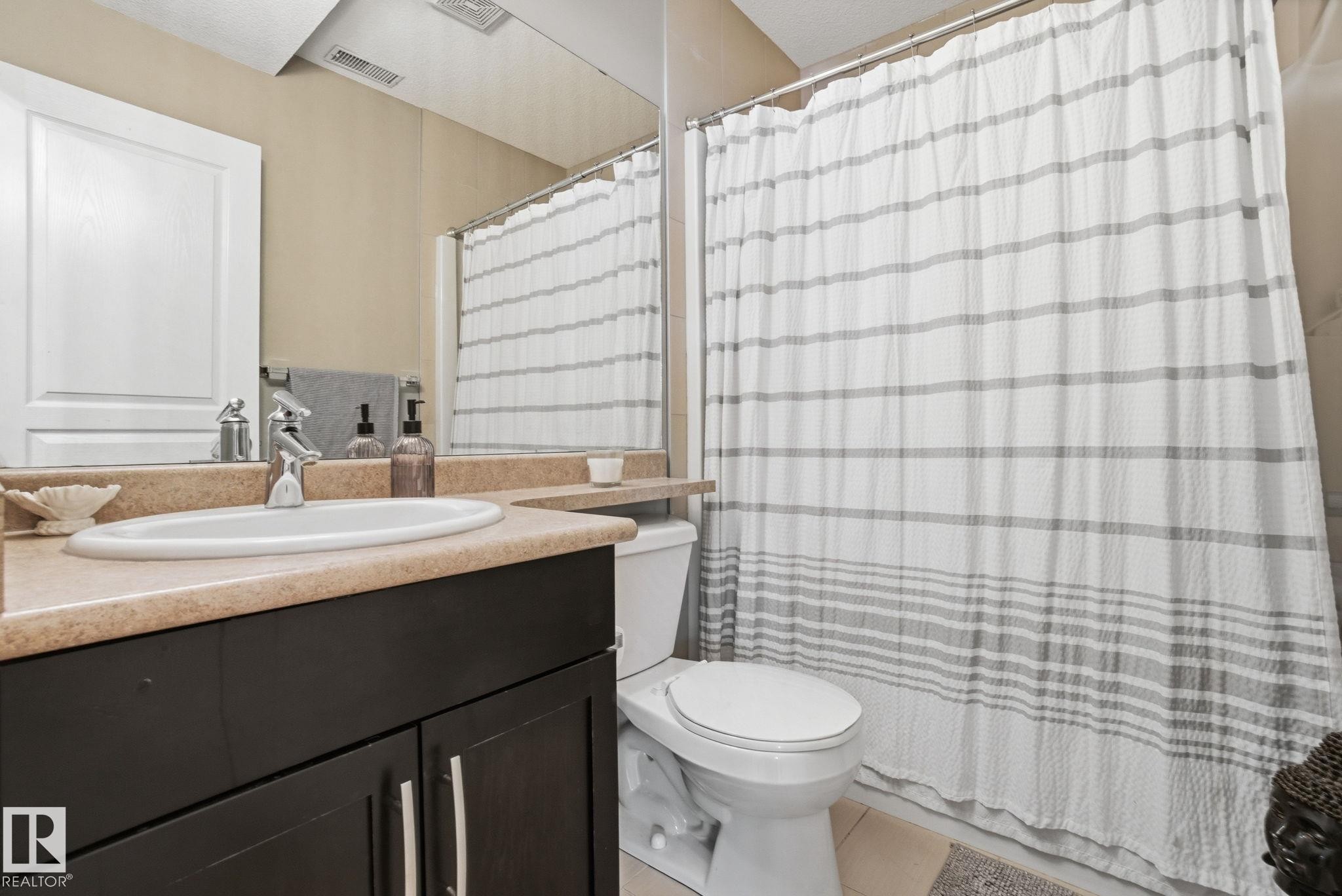 Full bathroom with vanity and light tile patterned flooring - 301 9603 98 Avenue, Edmonton, AB - Indoor Photo Showing Bathroom