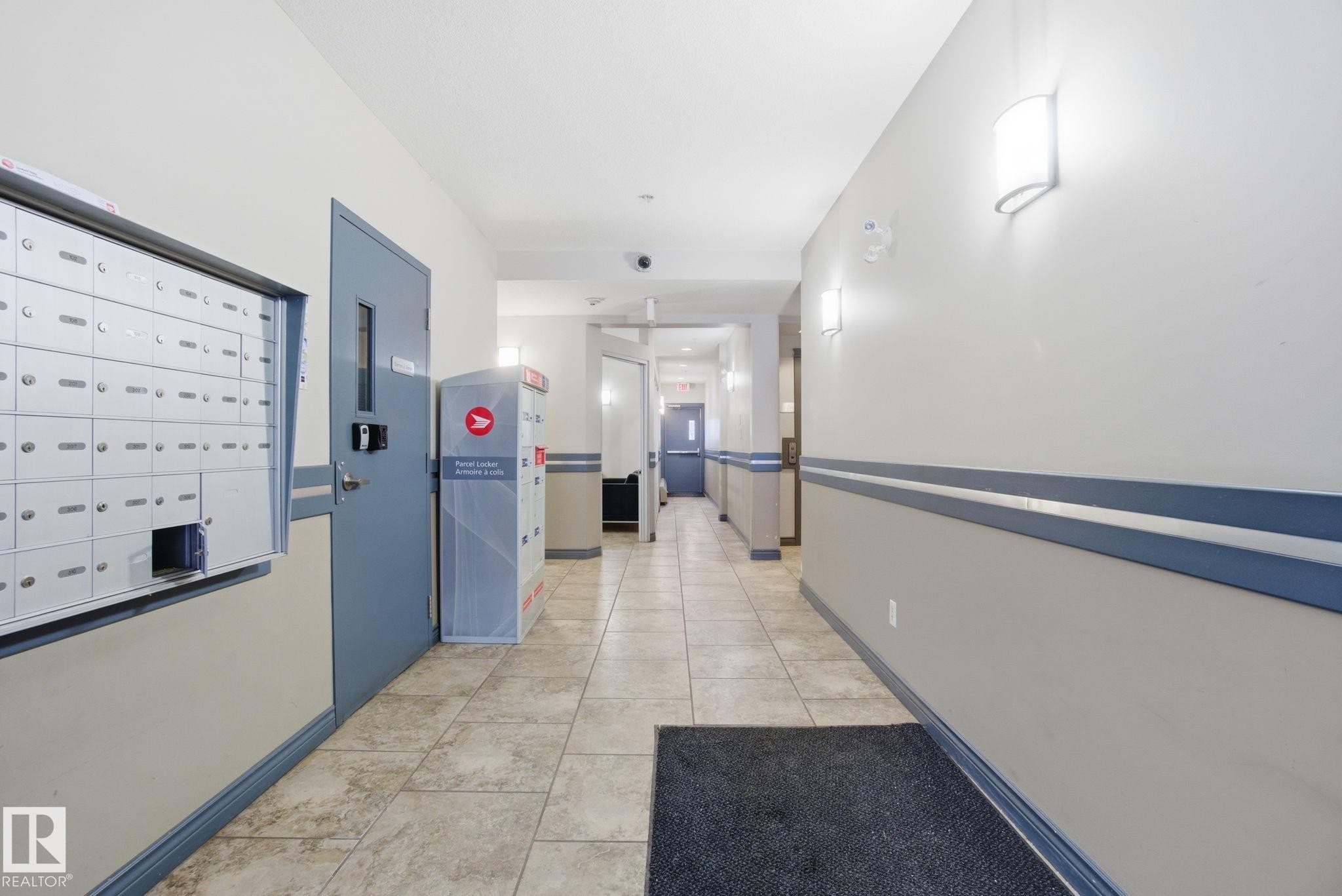 Hall featuring light tile patterned floors and mail area - 301 9603 98 Avenue, Edmonton, AB - Indoor Photo Showing Other Room