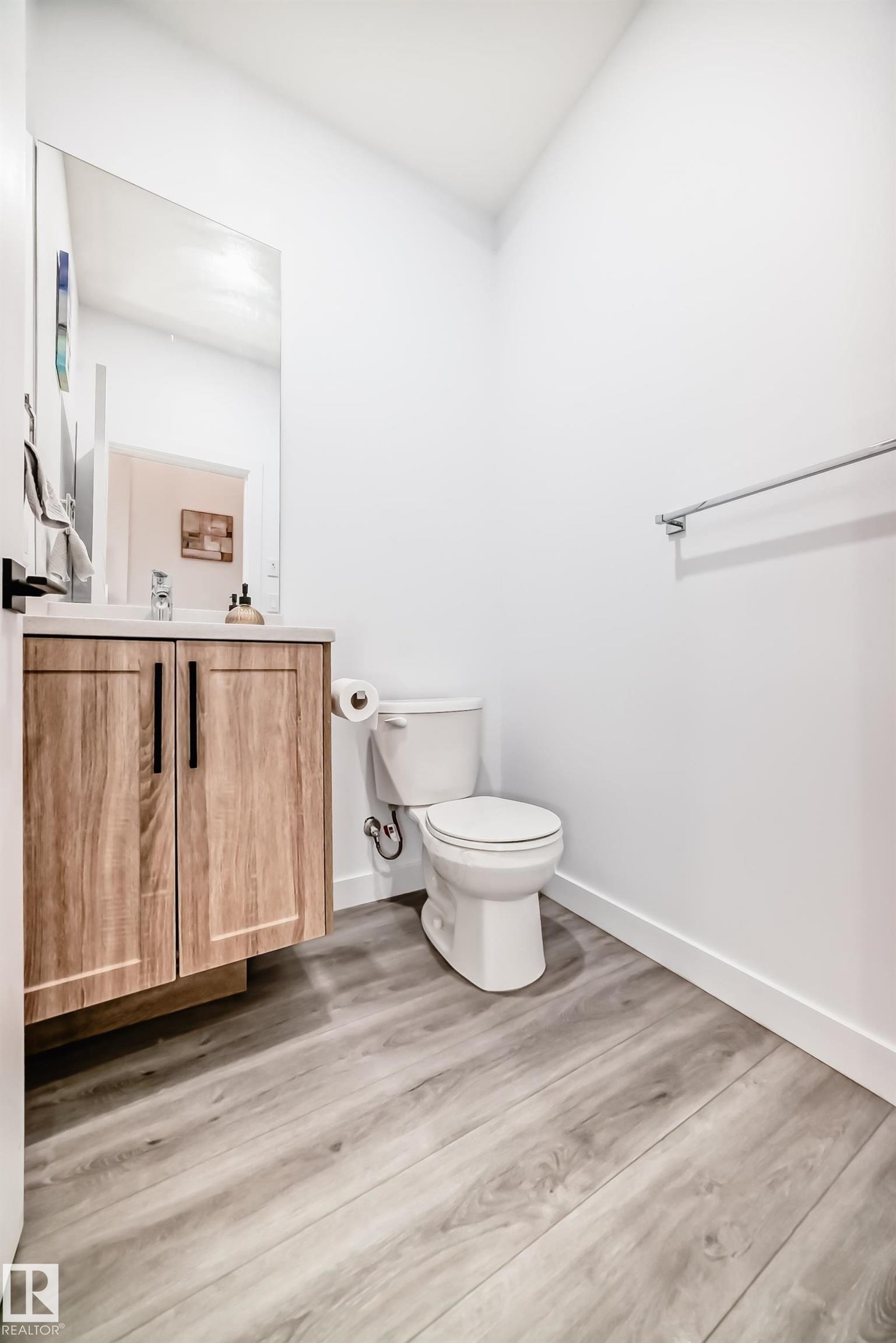 Half bathroom with vanity and light wood-style floors - 563 Kleins Cr, Leduc, AB - Indoor Photo Showing Bathroom
