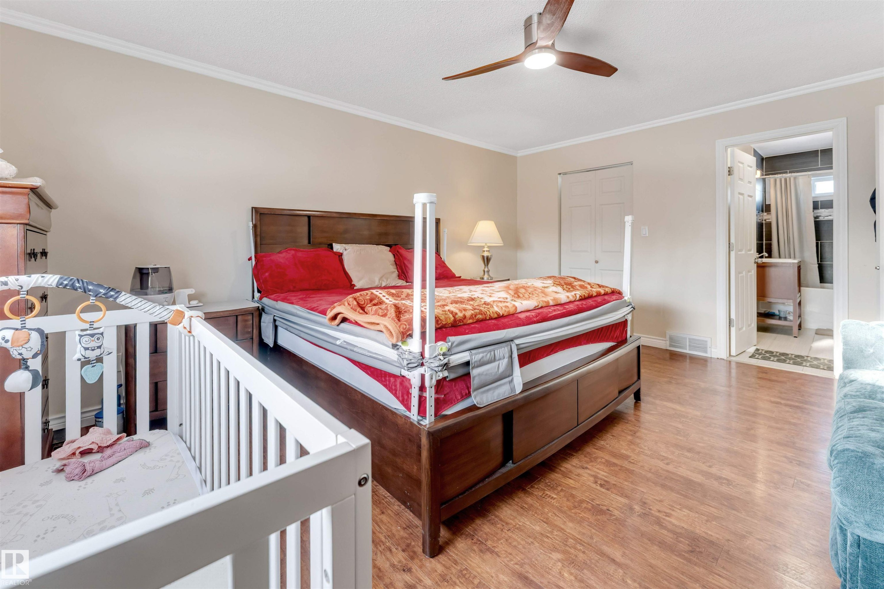 Bedroom featuring ornamental molding, a closet, light wood-style flooring, and ceiling fan - 18404 97A Avenue, Edmonton, AB - Indoor Photo Showing Bedroom