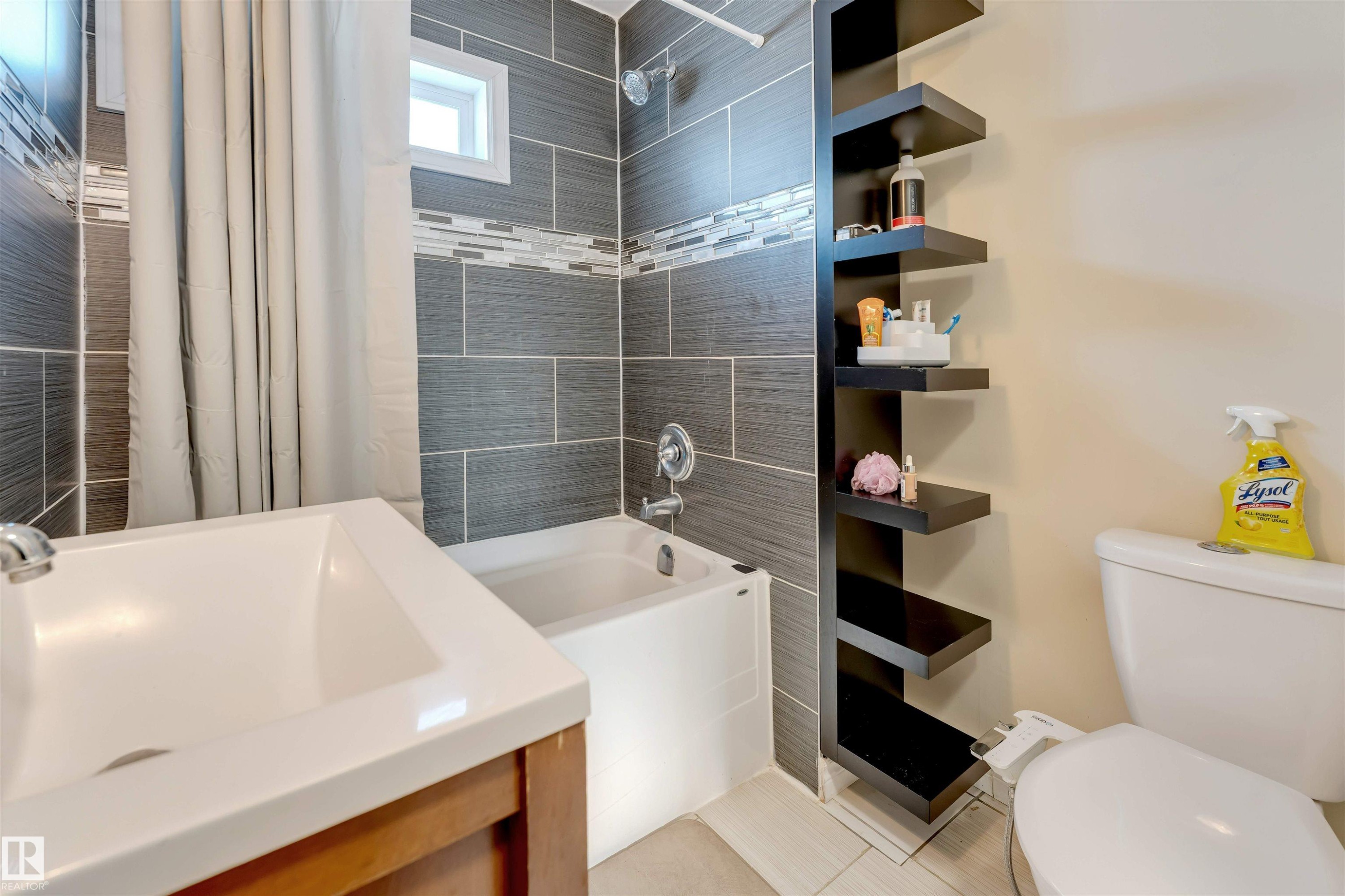 Bathroom with shower / bathtub combination with curtain, vanity, and light tile patterned floors - 18404 97A Avenue, Edmonton, AB - Indoor Photo Showing Bathroom