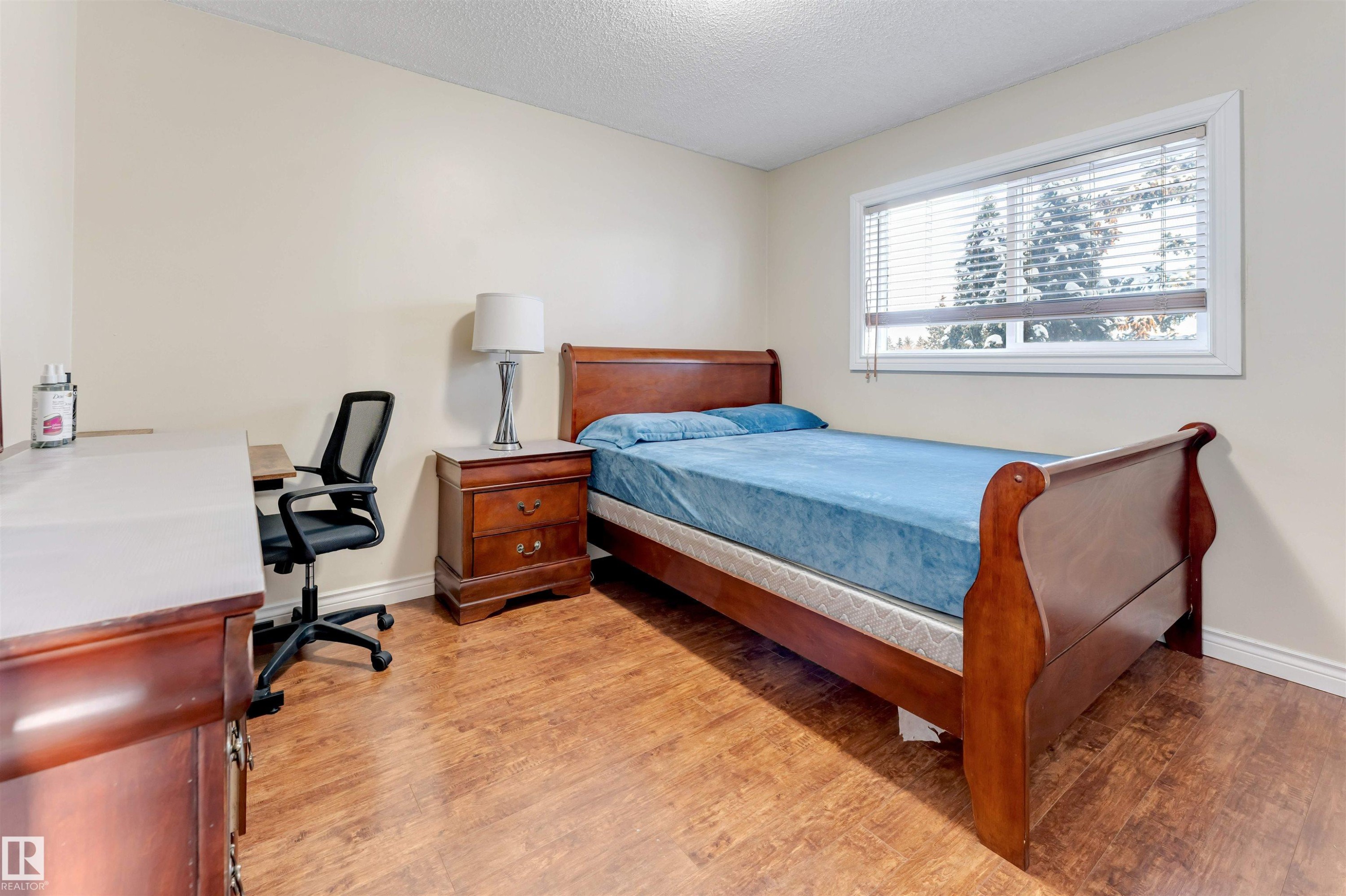 Bedroom featuring light wood-style floors, a textured ceiling, and a desk - 18404 97A Avenue, Edmonton, AB - Indoor Photo Showing Bedroom