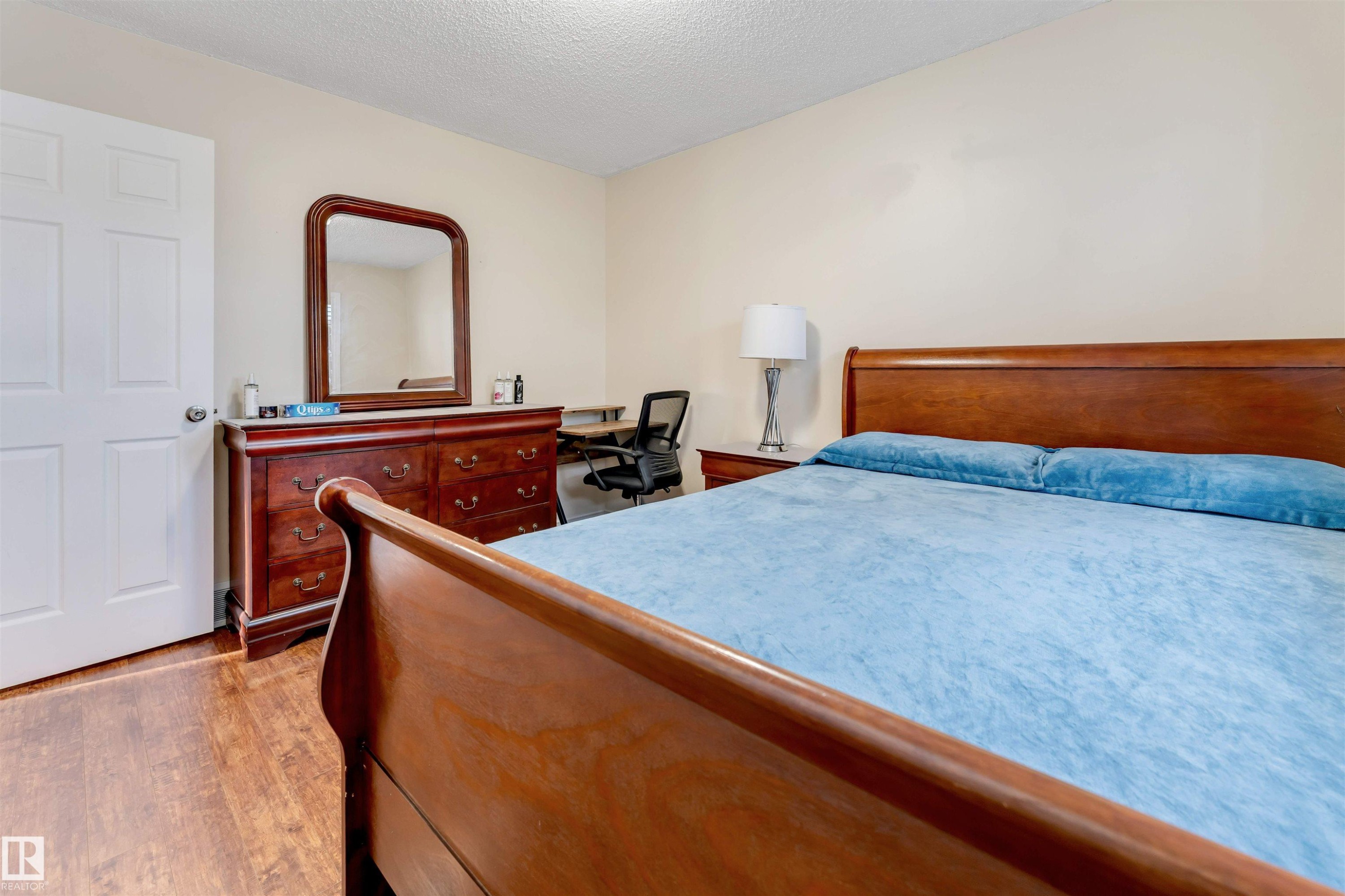 Bedroom with a textured ceiling, light wood-style flooring, and an office area - 18404 97A Avenue, Edmonton, AB - Indoor Photo Showing Bedroom