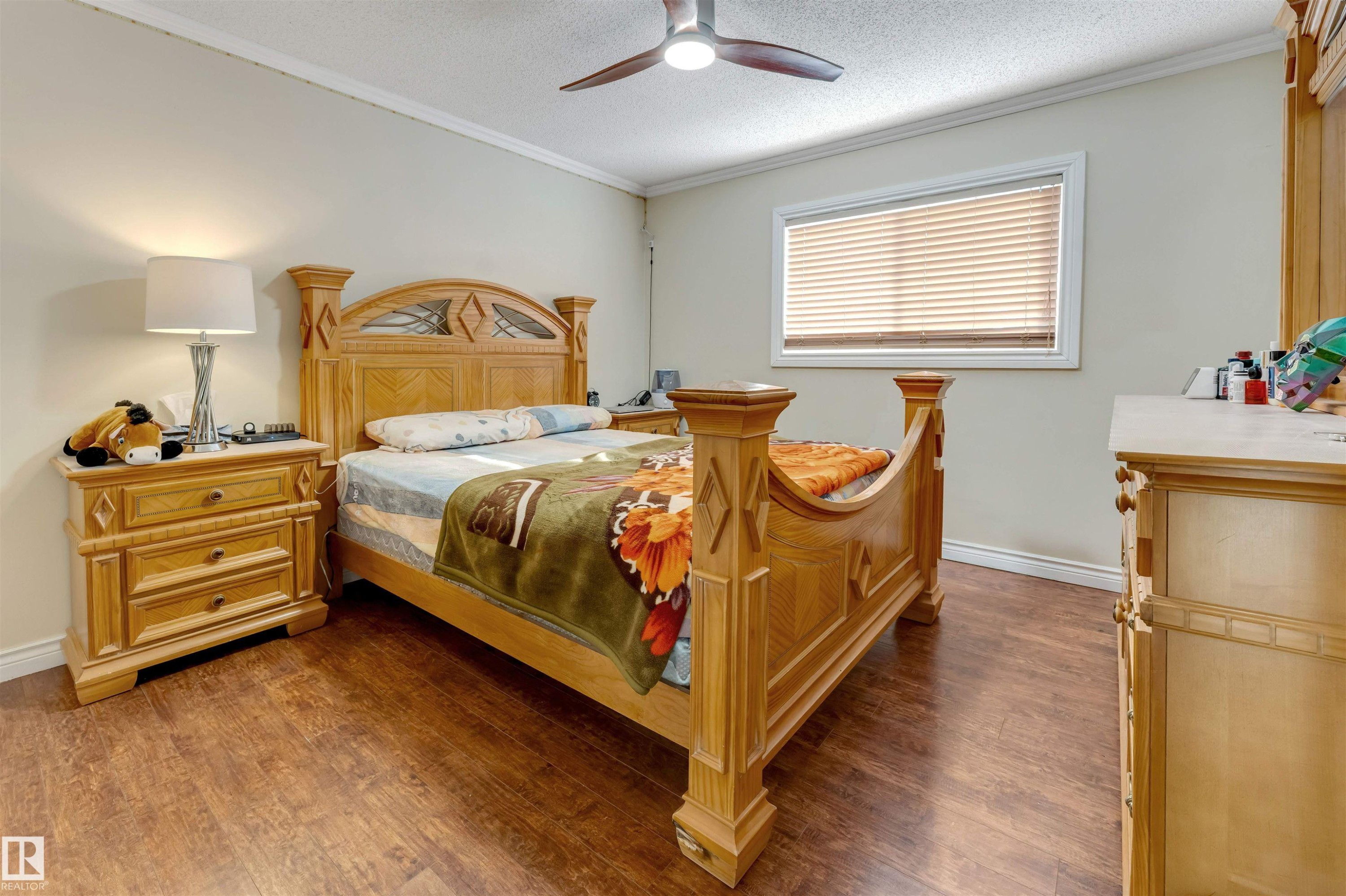 Bedroom with crown molding, a textured ceiling, dark wood-style floors, and a ceiling fan - 18404 97A Avenue, Edmonton, AB - Indoor Photo Showing Bedroom