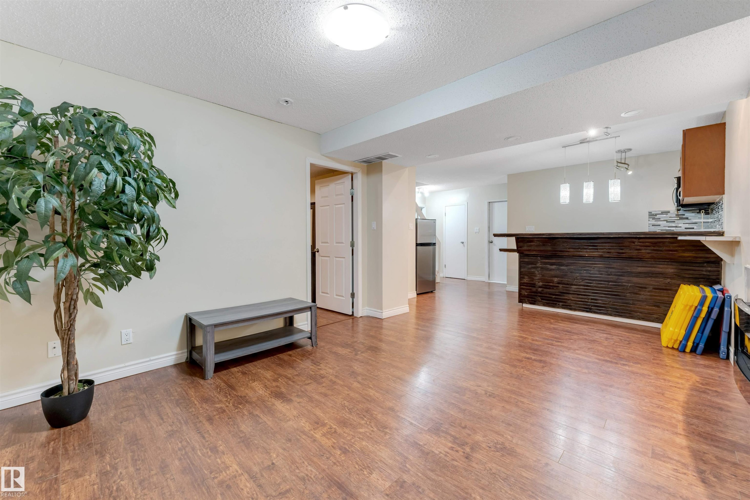 Living area with wood finished floors and a textured ceiling - 18404 97A Avenue, Edmonton, AB - Indoor