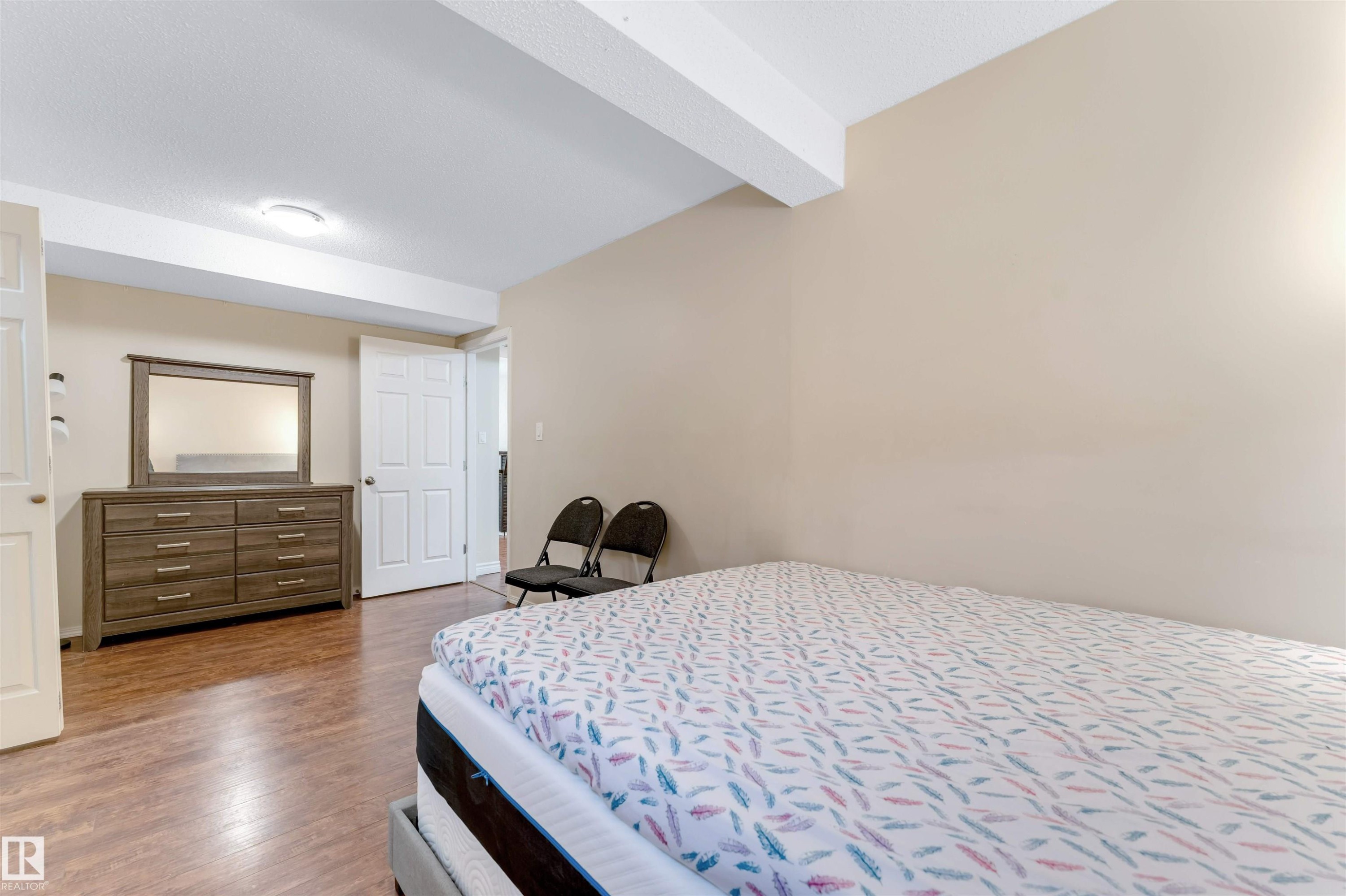 Bedroom with beamed ceiling and wood finished floors - 18404 97A Avenue, Edmonton, AB - Indoor Photo Showing Bedroom