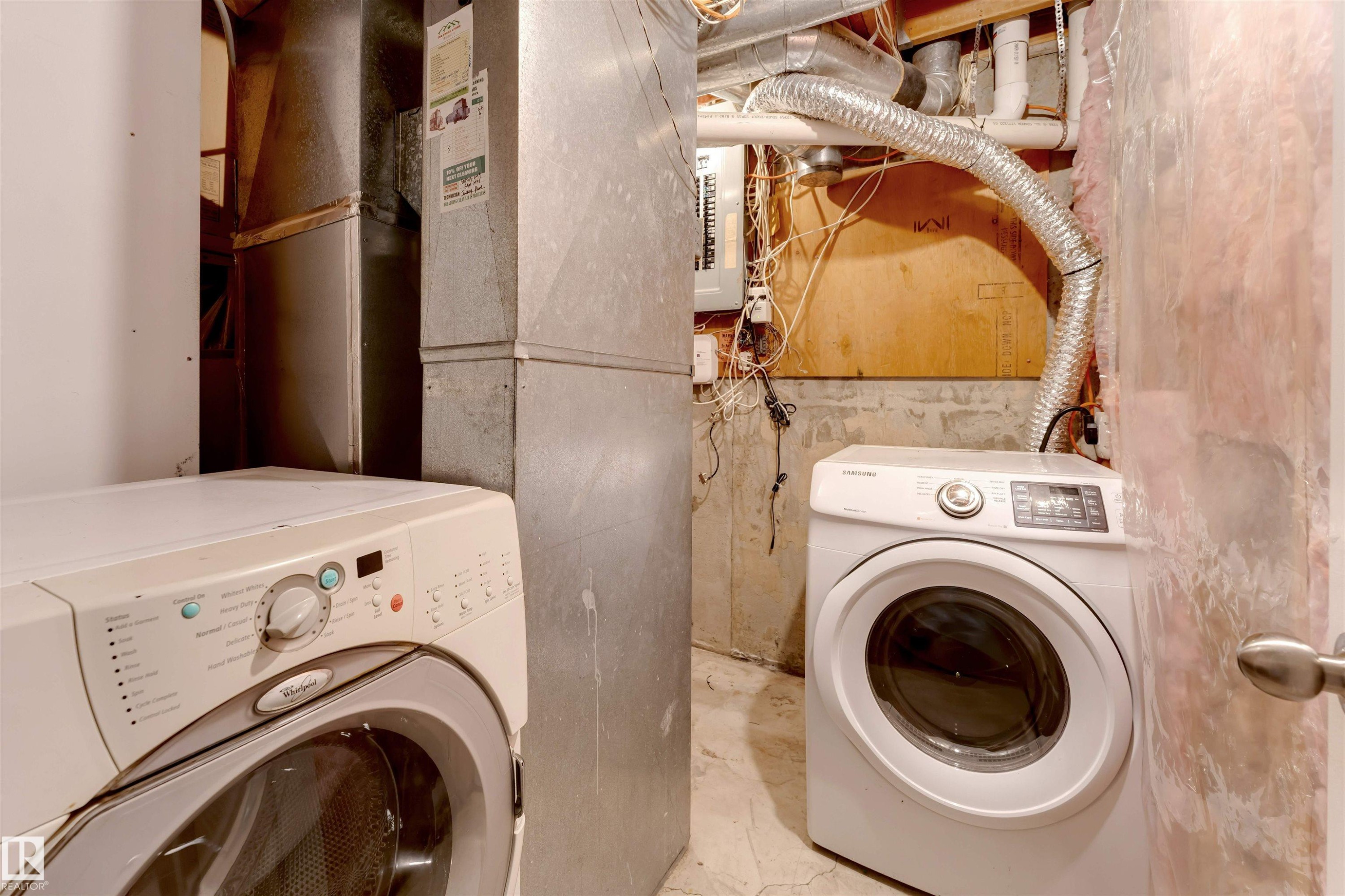Laundry area with unfinished concrete flooring, heating unit, and electric panel - 18404 97A Avenue, Edmonton, AB - Indoor Photo Showing Laundry Room