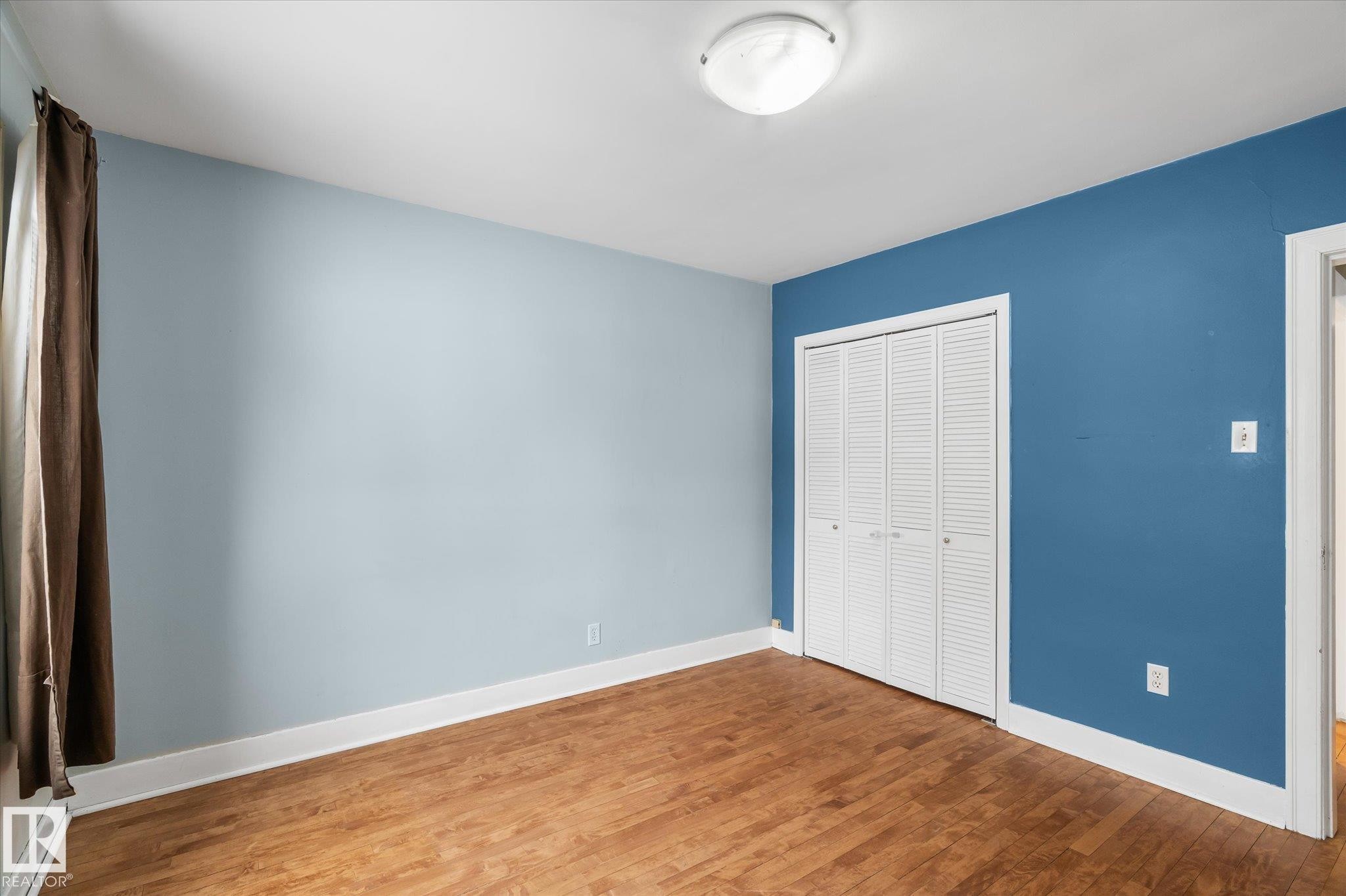 Unfurnished bedroom with wood finished floors and a closet - 10429 143 Street, Edmonton, AB - Indoor Photo Showing Other Room