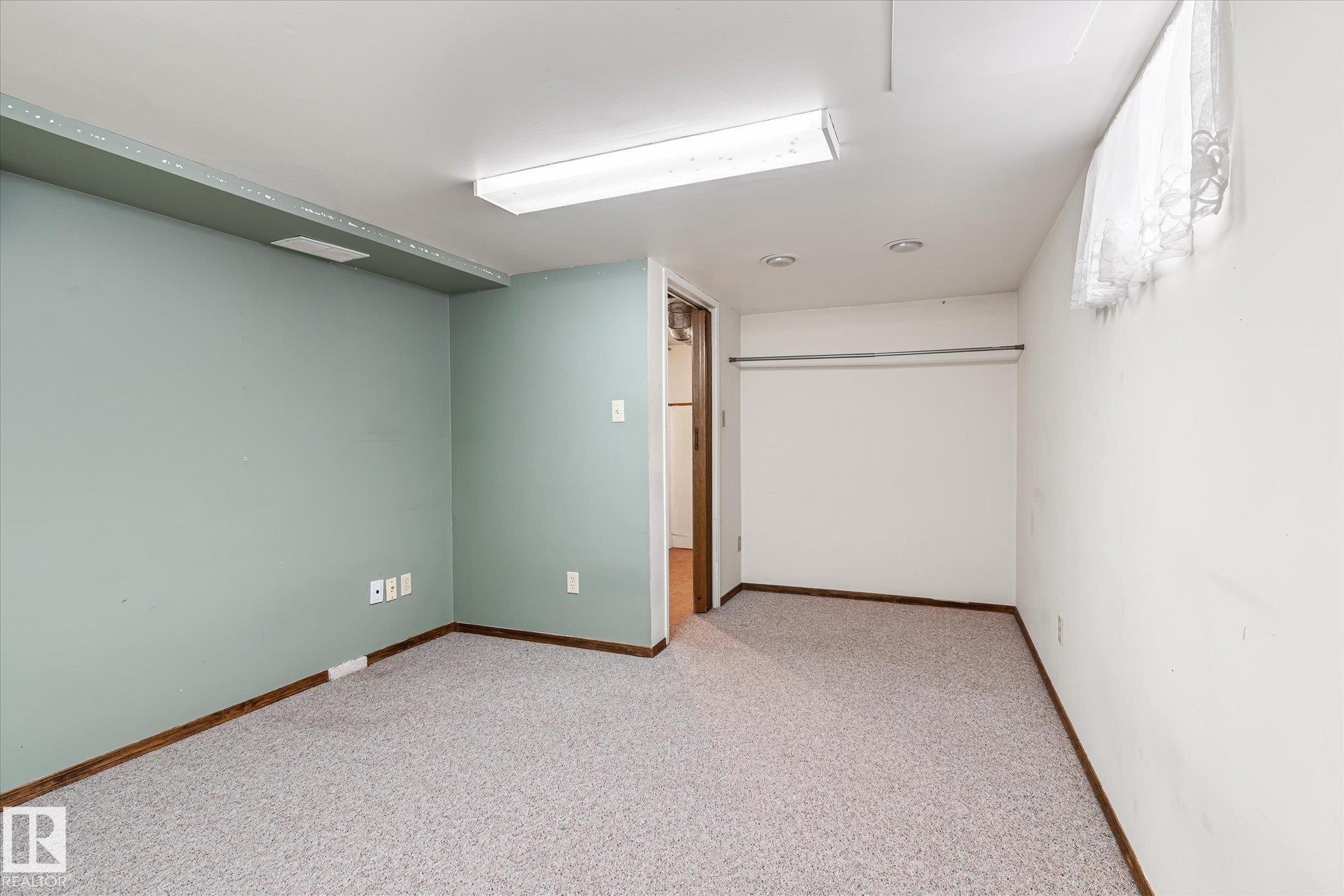 Finished below grade area featuring light carpet and baseboards - 10429 143 Street, Edmonton, AB - Indoor Photo Showing Other Room