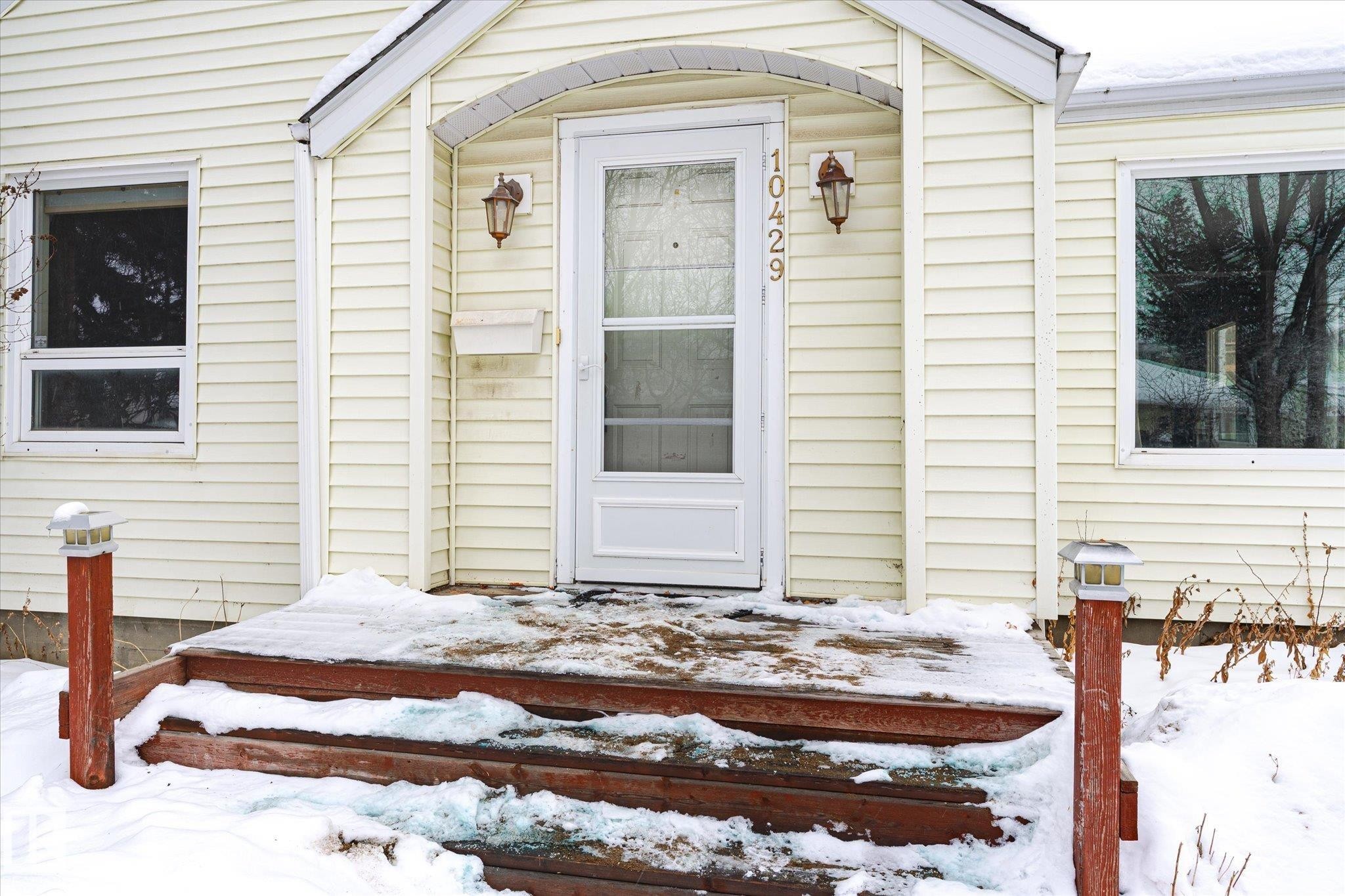 Snow covered property entrance with a wooden deck - 10429 143 Street, Edmonton, AB - Outdoor With Exterior