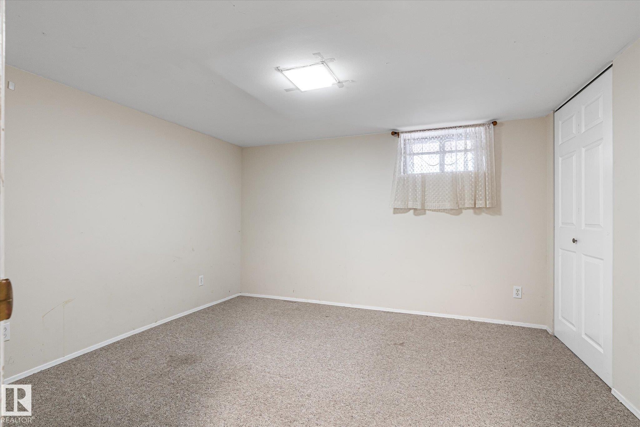 Below grade area with carpet flooring and baseboards - 10429 143 Street, Edmonton, AB - Indoor Photo Showing Other Room