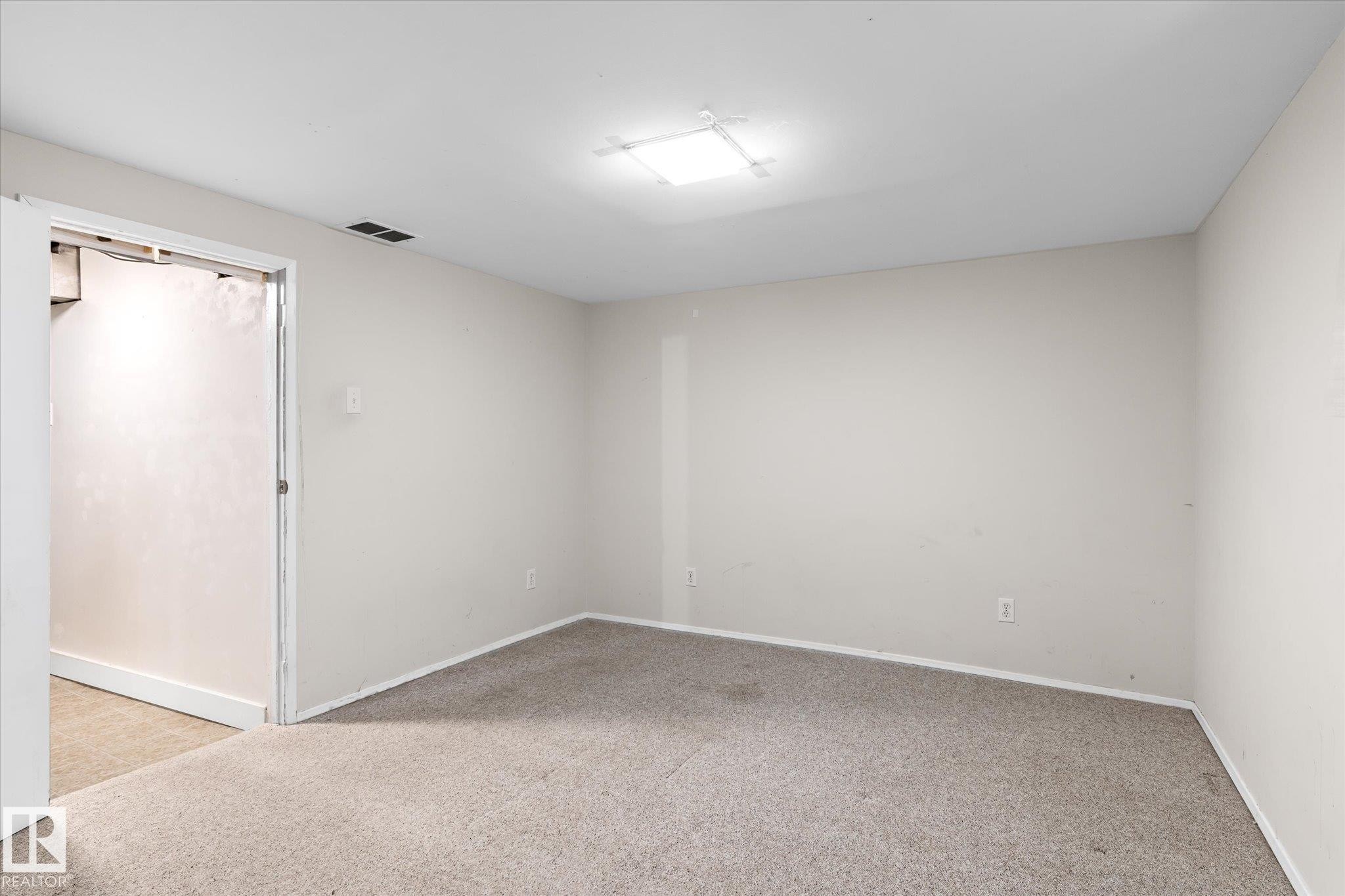 Empty room featuring light carpet and baseboards - 10429 143 Street, Edmonton, AB - Indoor Photo Showing Other Room