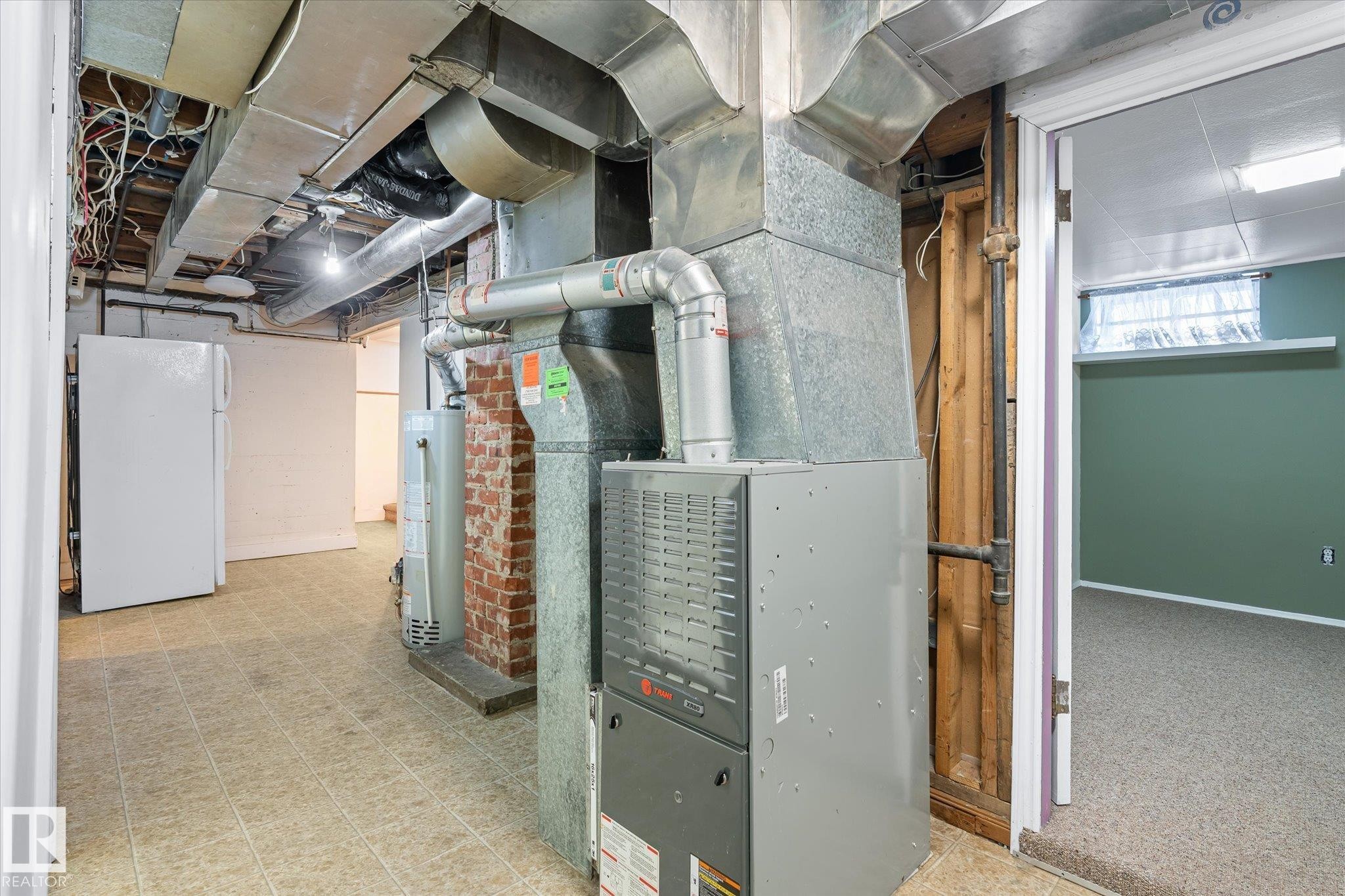Utility room featuring water heater and heating unit - 10429 143 Street, Edmonton, AB - Indoor Photo Showing Basement