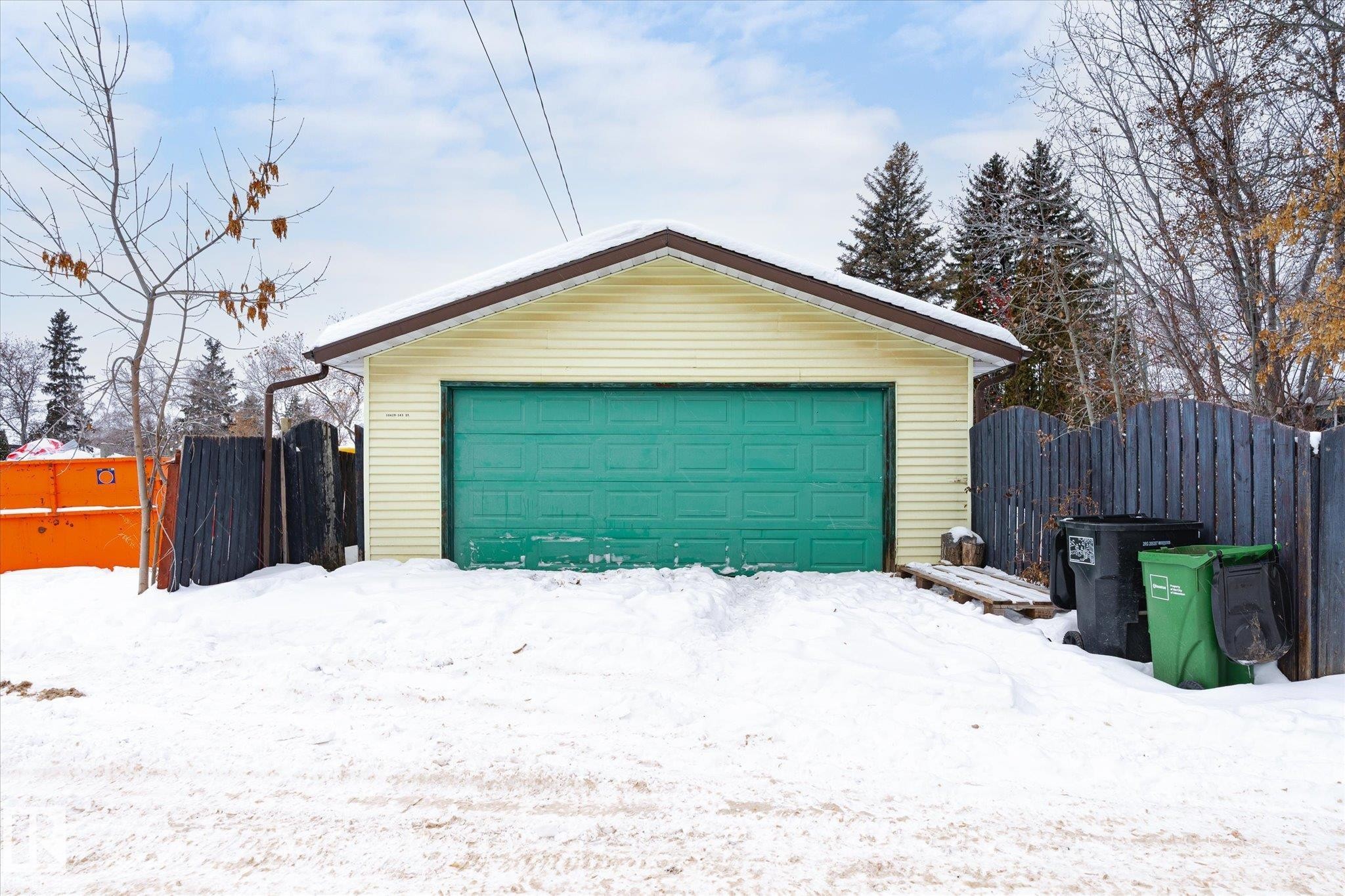 Snow covered garage featuring a garage and a gate - 10429 143 Street, Edmonton, AB - Outdoor