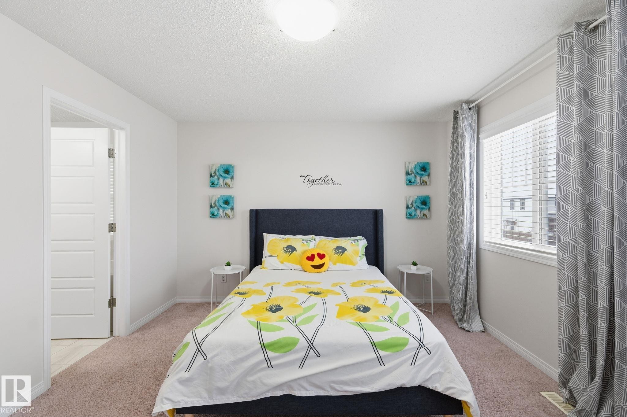 Bedroom with light colored carpet and a textured ceiling - 1511 Secord Rd, Edmonton, AB - Indoor Photo Showing Bedroom