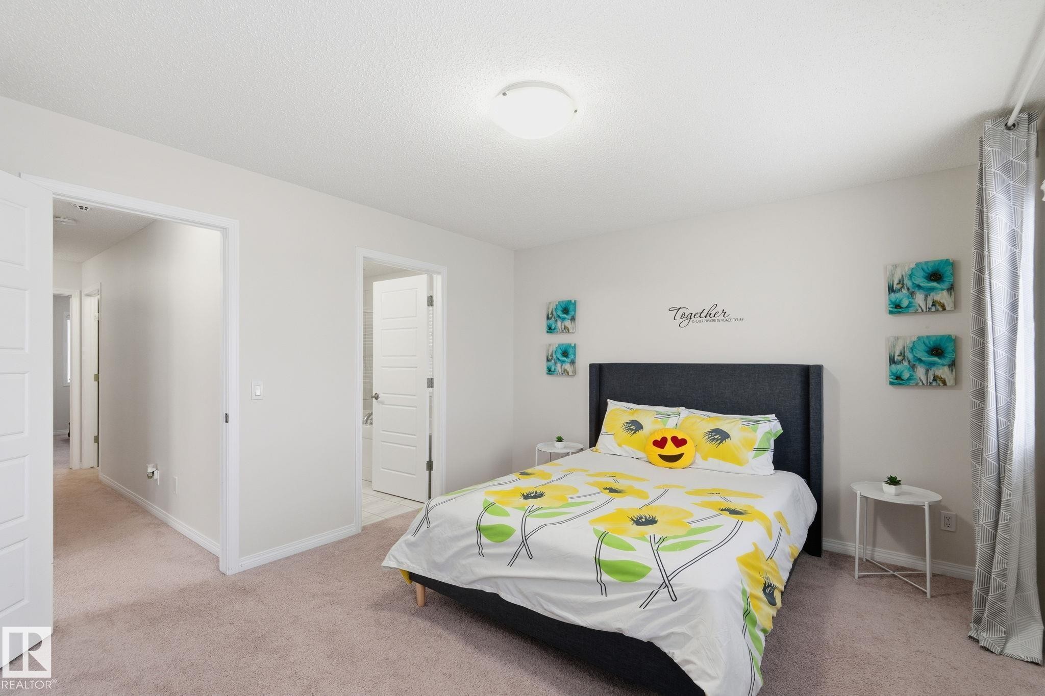 Bedroom with light carpet and a textured ceiling - 1511 Secord Rd, Edmonton, AB - Indoor Photo Showing Bedroom