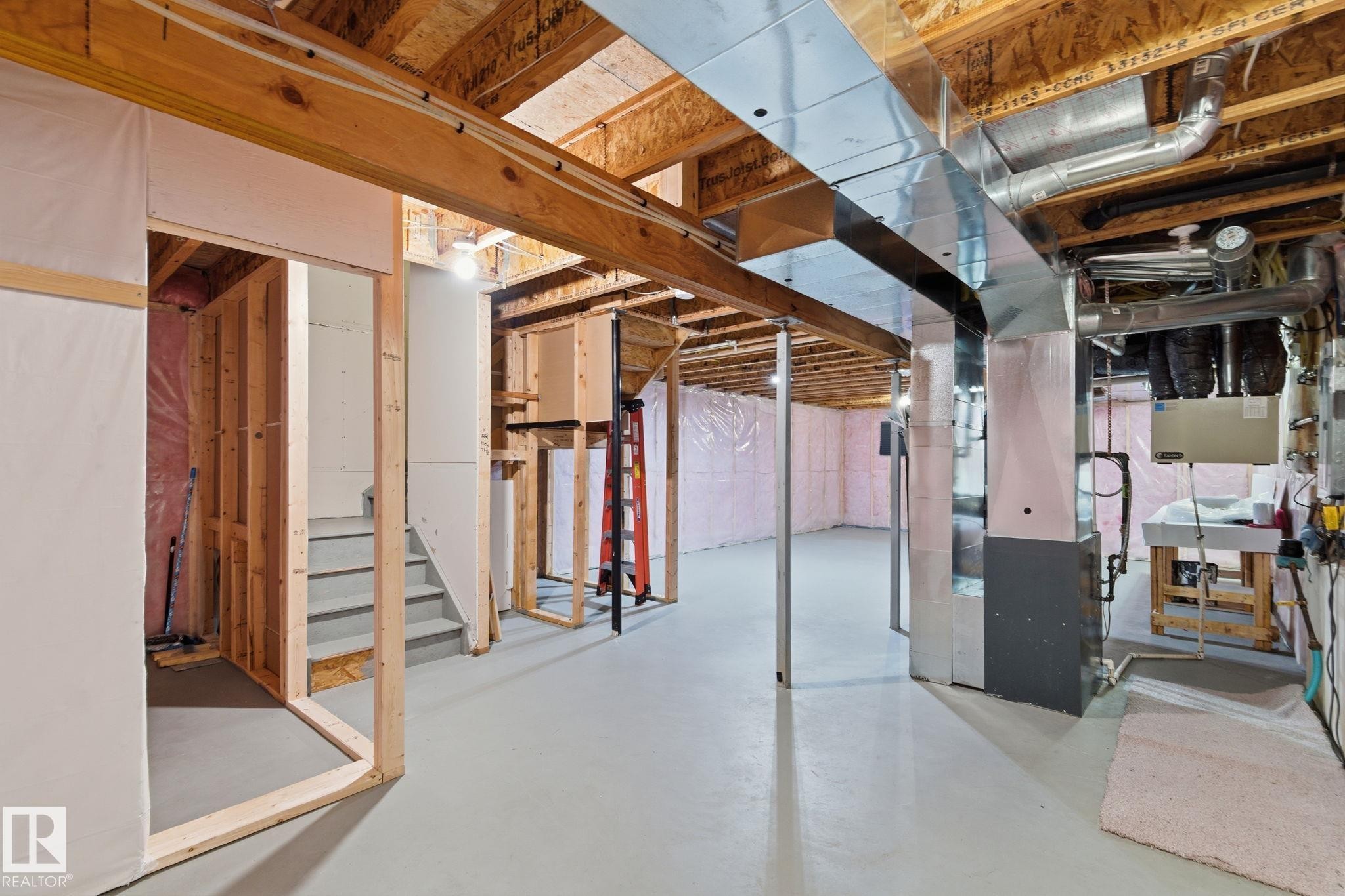 Unfinished below grade area featuring heating unit and a sink - 1511 Secord Rd, Edmonton, AB - Indoor Photo Showing Basement