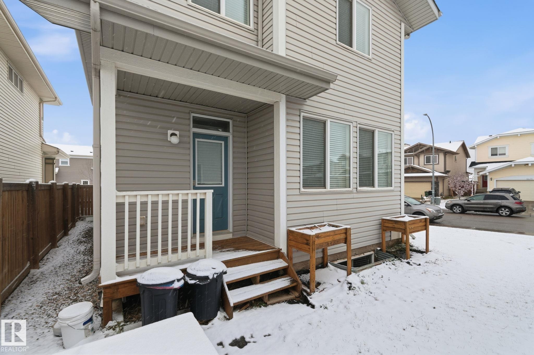 Doorway to property featuring a wooden deck - 1511 Secord Rd, Edmonton, AB - Outdoor With Exterior