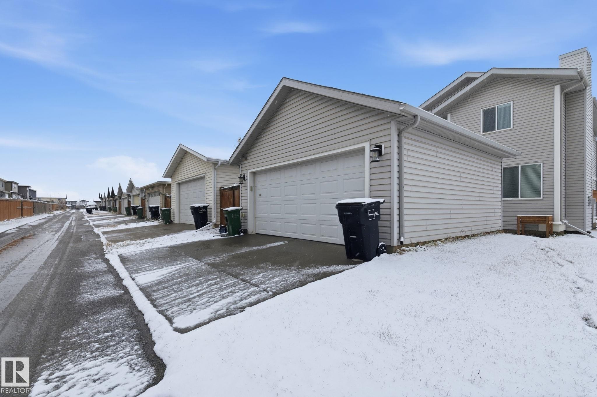 View of snowy exterior with an attached garage - 1511 Secord Rd, Edmonton, AB - Outdoor