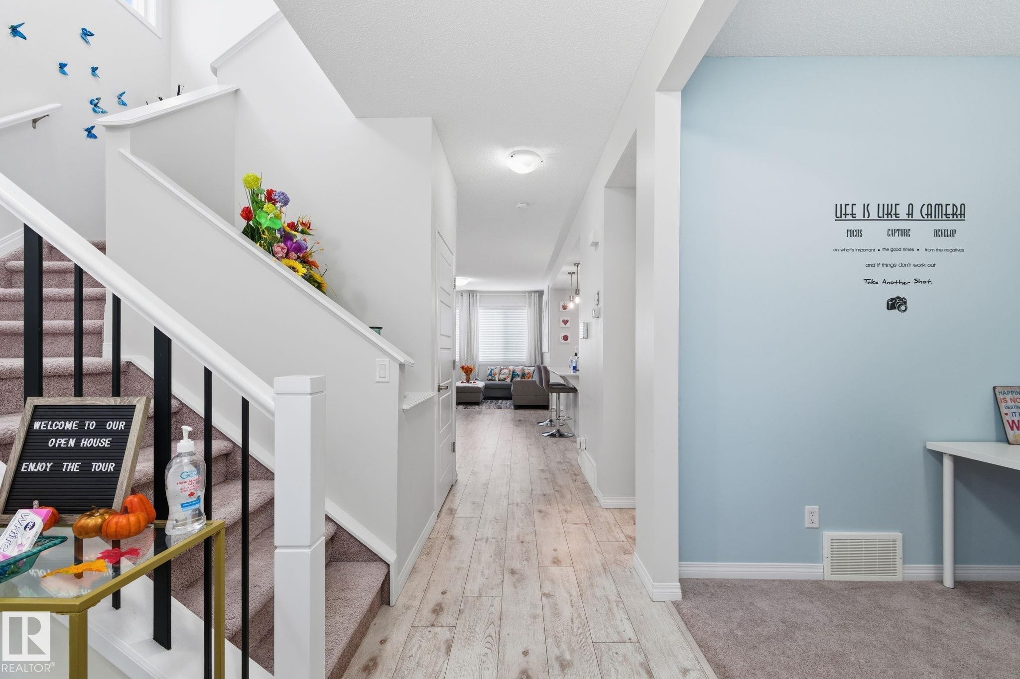 Hall with healthy amount of natural light, light wood finished floors, and stairway - 1511 Secord Rd, Edmonton, AB - Indoor Photo Showing Other Room