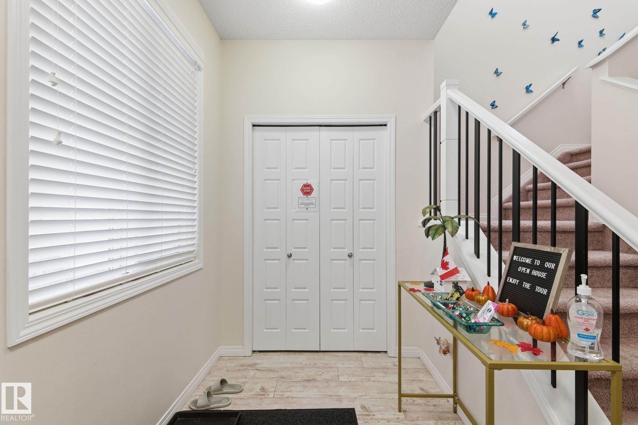 Entryway with light wood-style floors, stairs, and a textured ceiling - 1511 Secord Rd, Edmonton, AB - Indoor Photo Showing Other Room