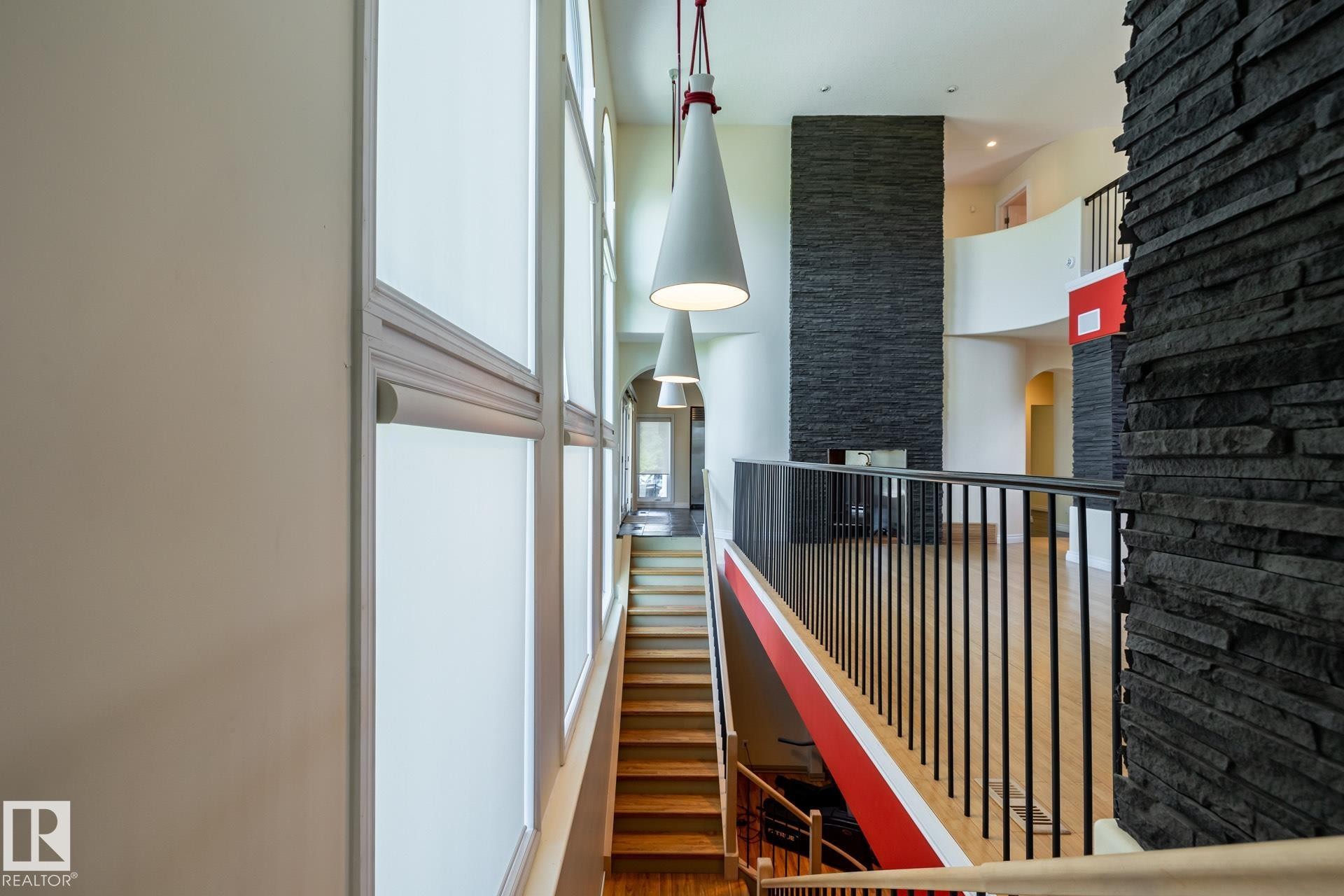 Corridor featuring a towering ceiling and wood finished floors - 12428 103 Avenue Nw, Edmonton, AB - Indoor Photo Showing Other Room