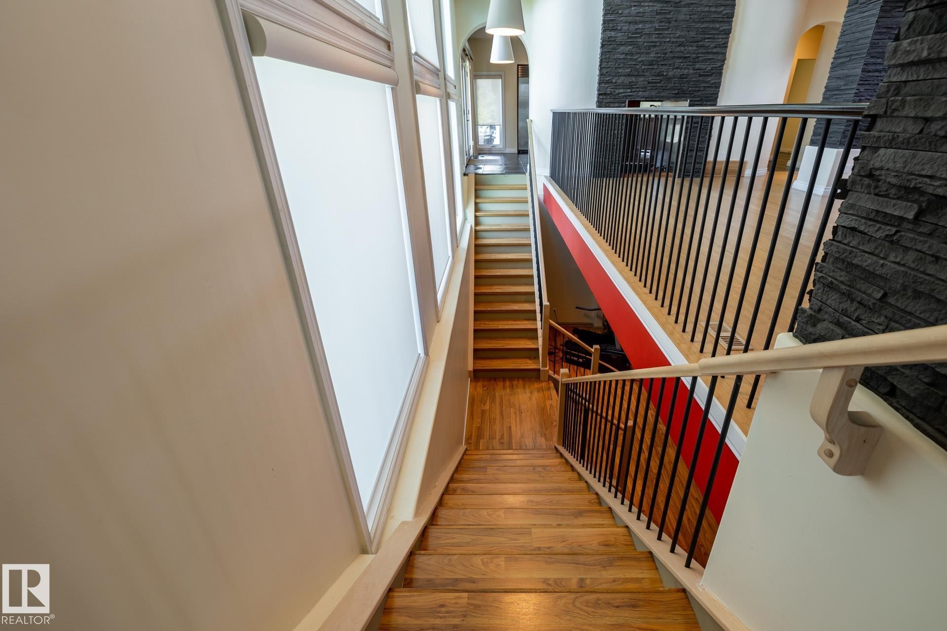 Stairway with hardwood / wood-style flooring and arched walkways - 12428 103 Avenue Nw, Edmonton, AB - Indoor Photo Showing Other Room