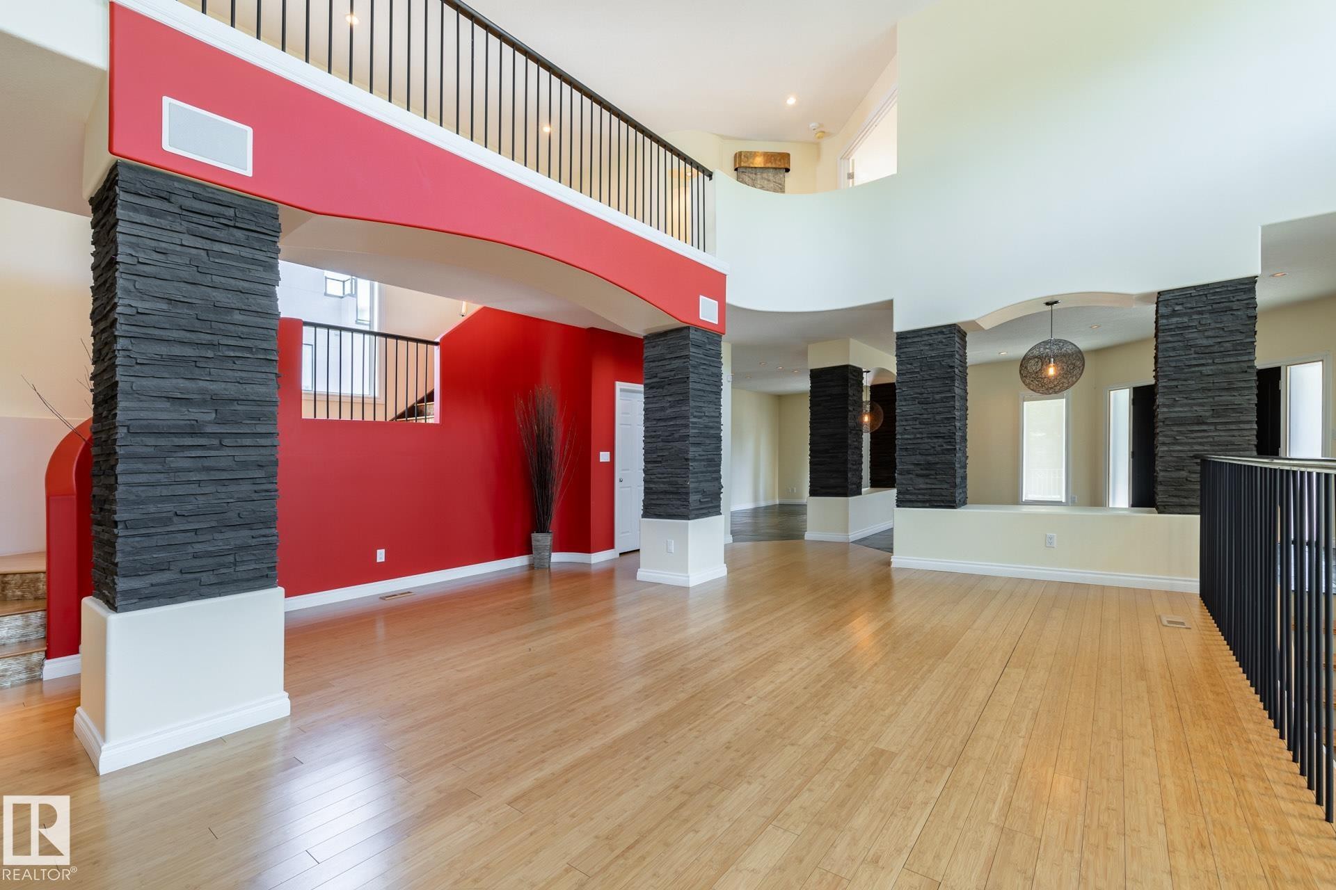 Unfurnished living room featuring light wood-type flooring and a towering ceiling - 12428 103 Avenue Nw, Edmonton, AB - Indoor Photo Showing Other Room