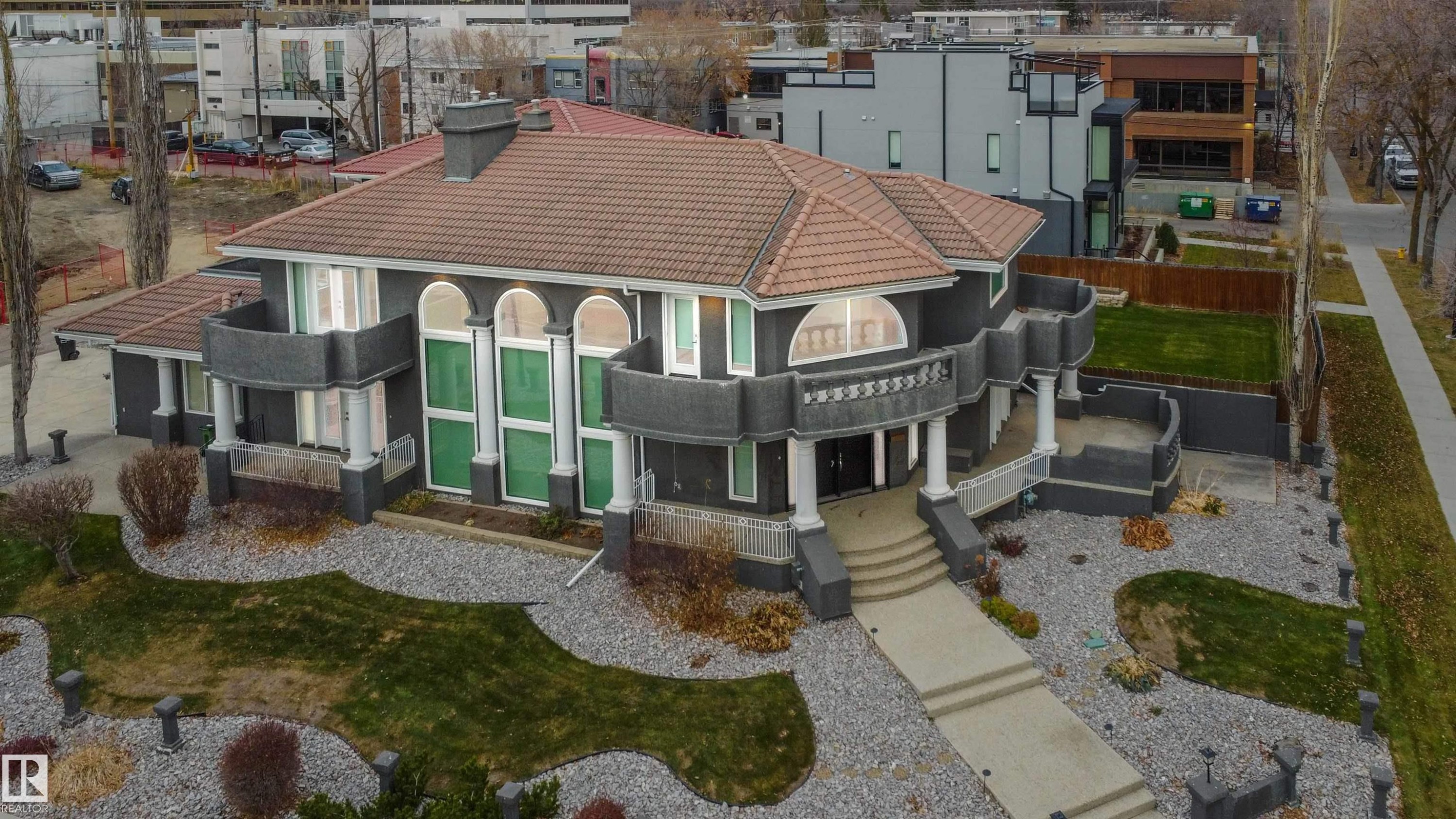 View of front of property with a tiled roof, stucco siding, and a porch - 12428 103 Avenue Nw, Edmonton, AB - Outdoor