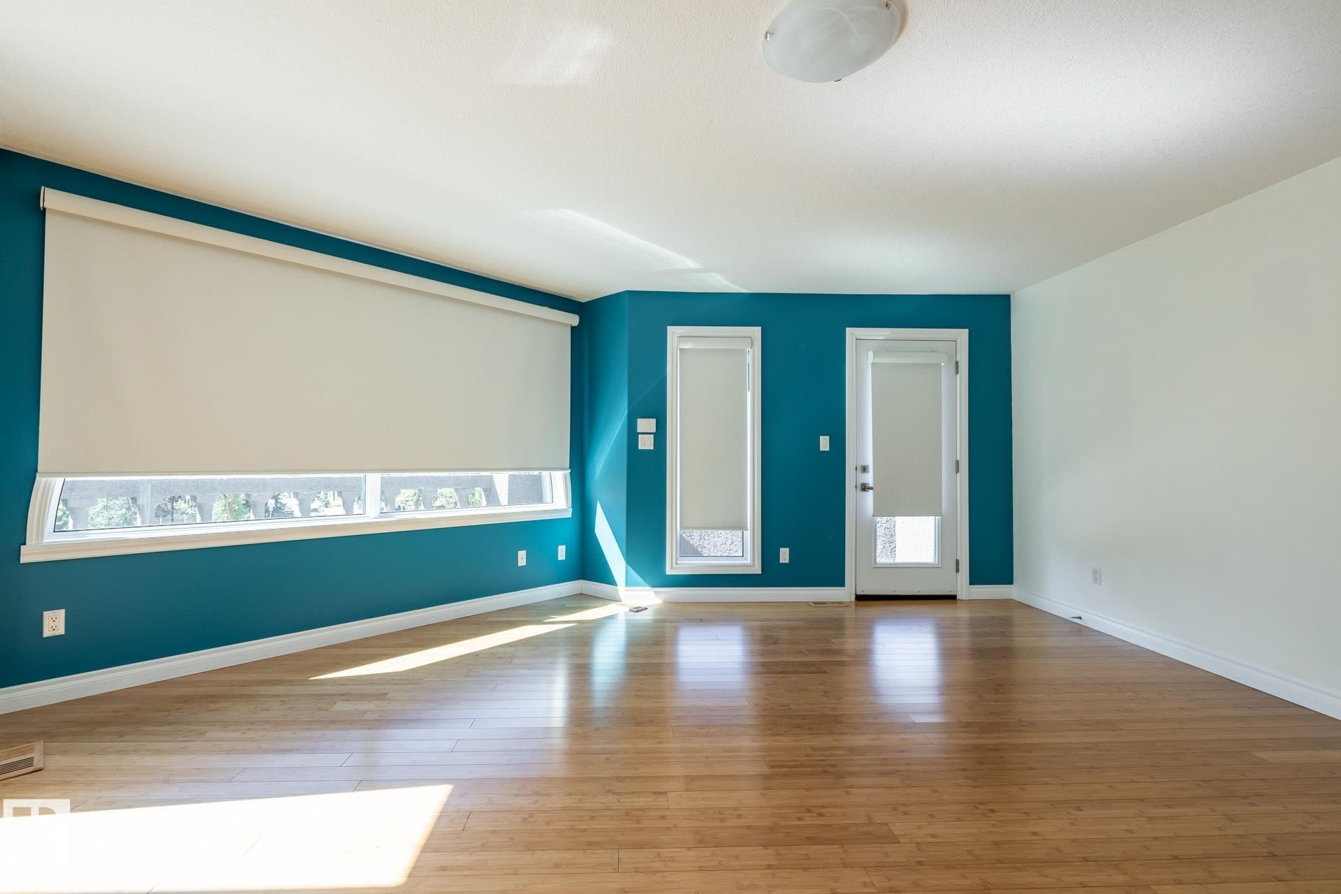 Spare room with light wood finished floors - 12428 103 Avenue Nw, Edmonton, AB - Indoor Photo Showing Other Room