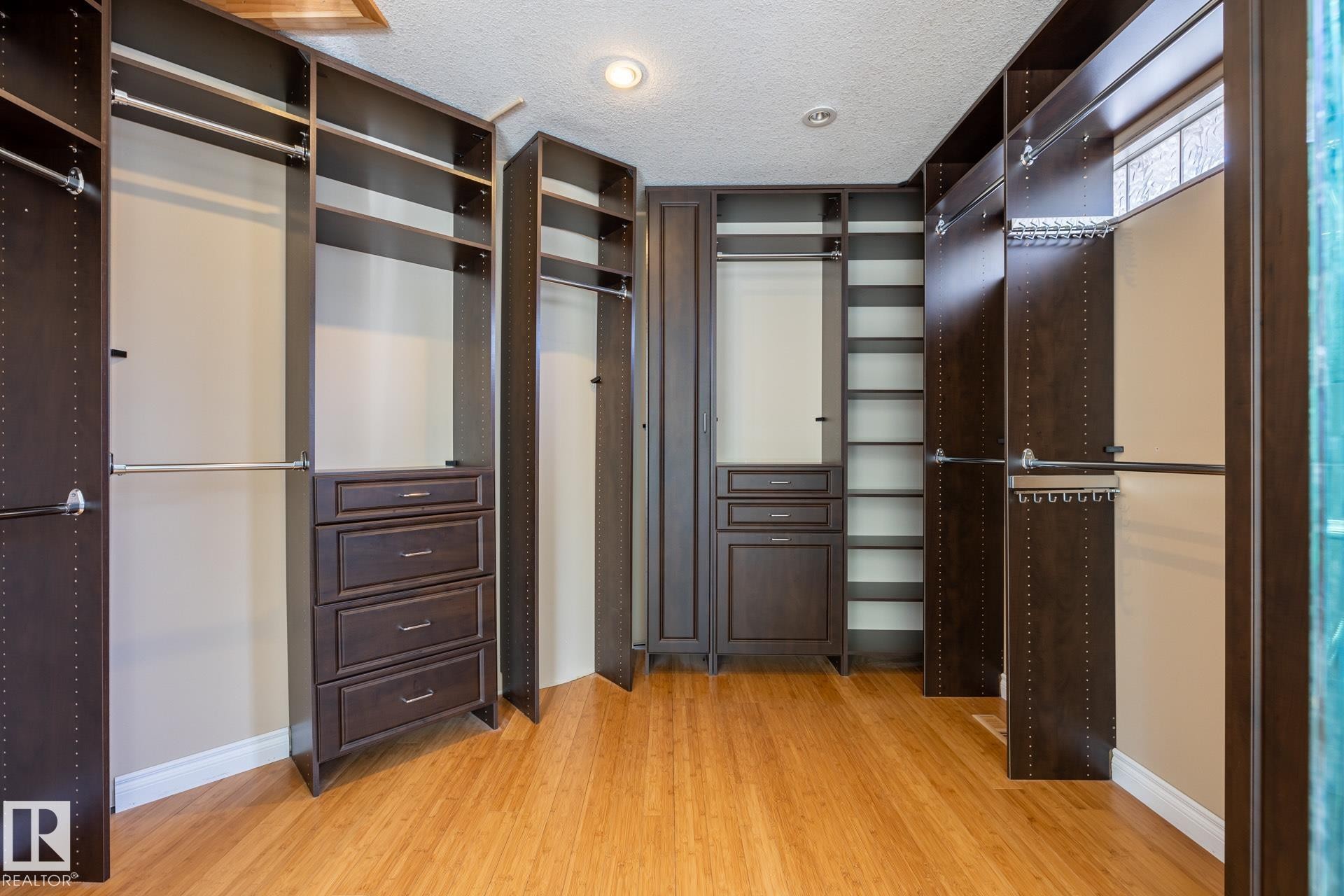 Walk in closet featuring light wood-style flooring - 12428 103 Avenue Nw, Edmonton, AB - Indoor Photo Showing Other Room