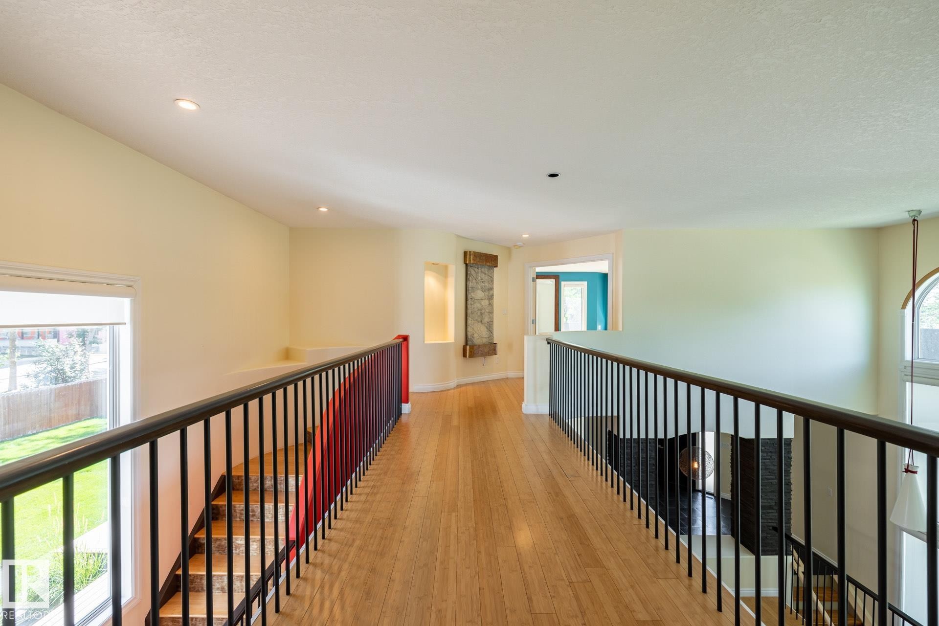 Hallway featuring healthy amount of natural light, light wood-style floors, a textured ceiling, and recessed lighting - 12428 103 Avenue Nw, Edmonton, AB - Indoor Photo Showing Other Room