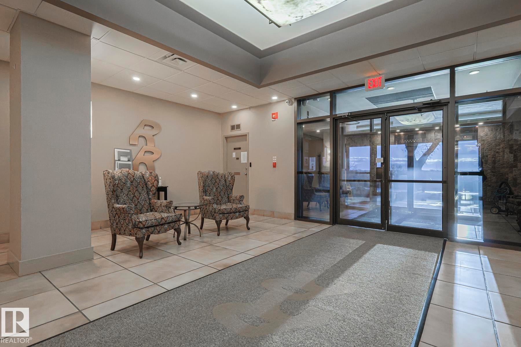 Community lobby featuring a wall of windows and recessed lighting - 302 8340 Jasper Avenue Nw, Edmonton, AB - Indoor Photo Showing Other Room