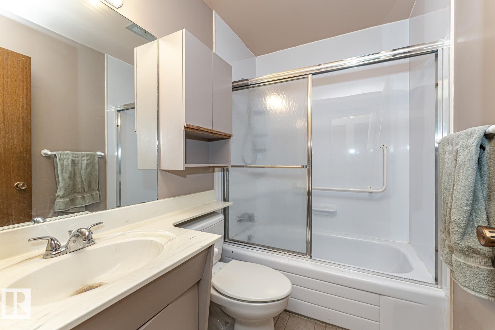Full bathroom with vanity and combined bath / shower with glass door - 10207 165 Avenue, Edmonton, AB - Indoor Photo Showing Bathroom