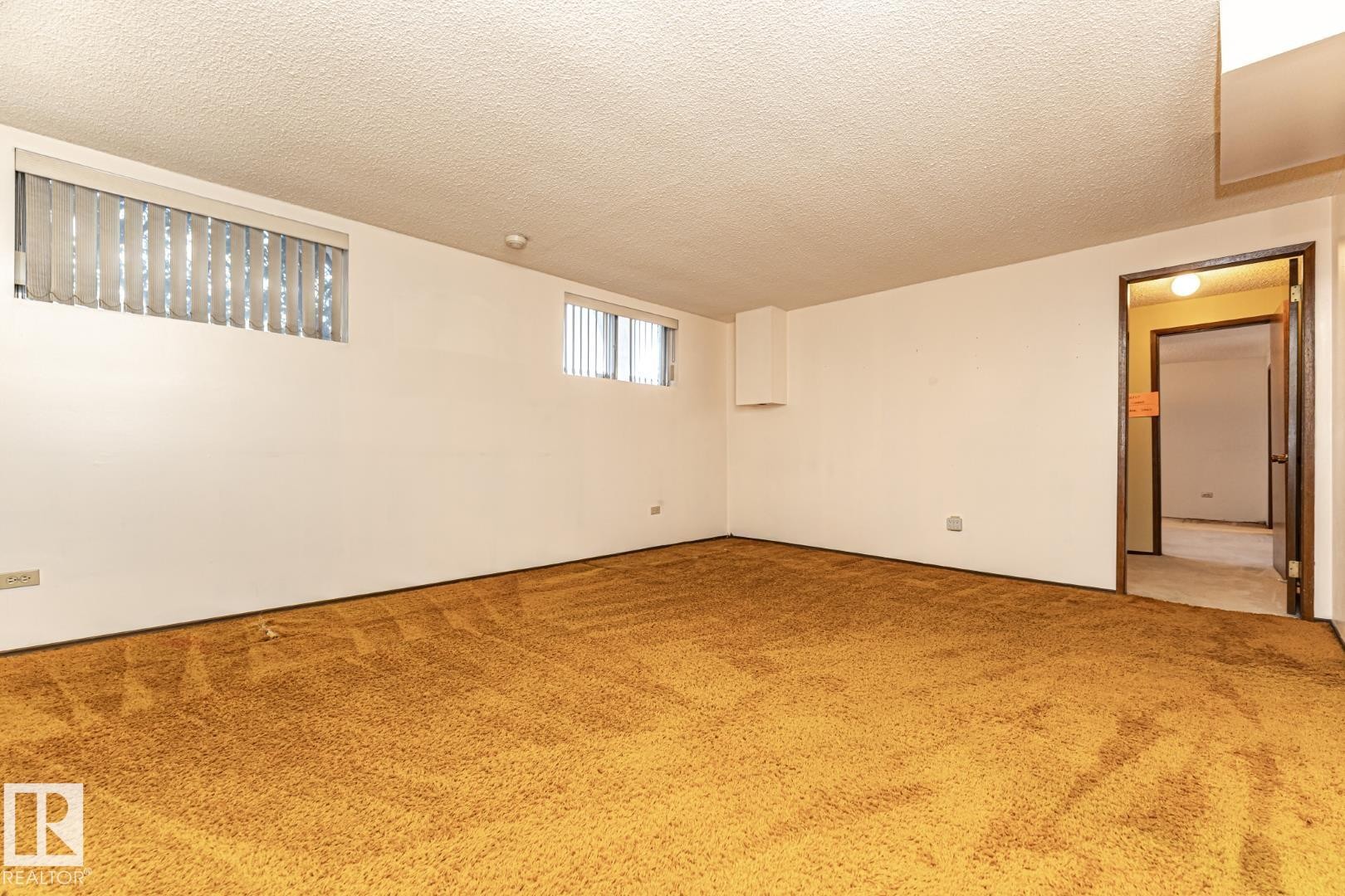 Carpeted spare room featuring a textured ceiling - 10207 165 Avenue, Edmonton, AB - Indoor Photo Showing Other Room