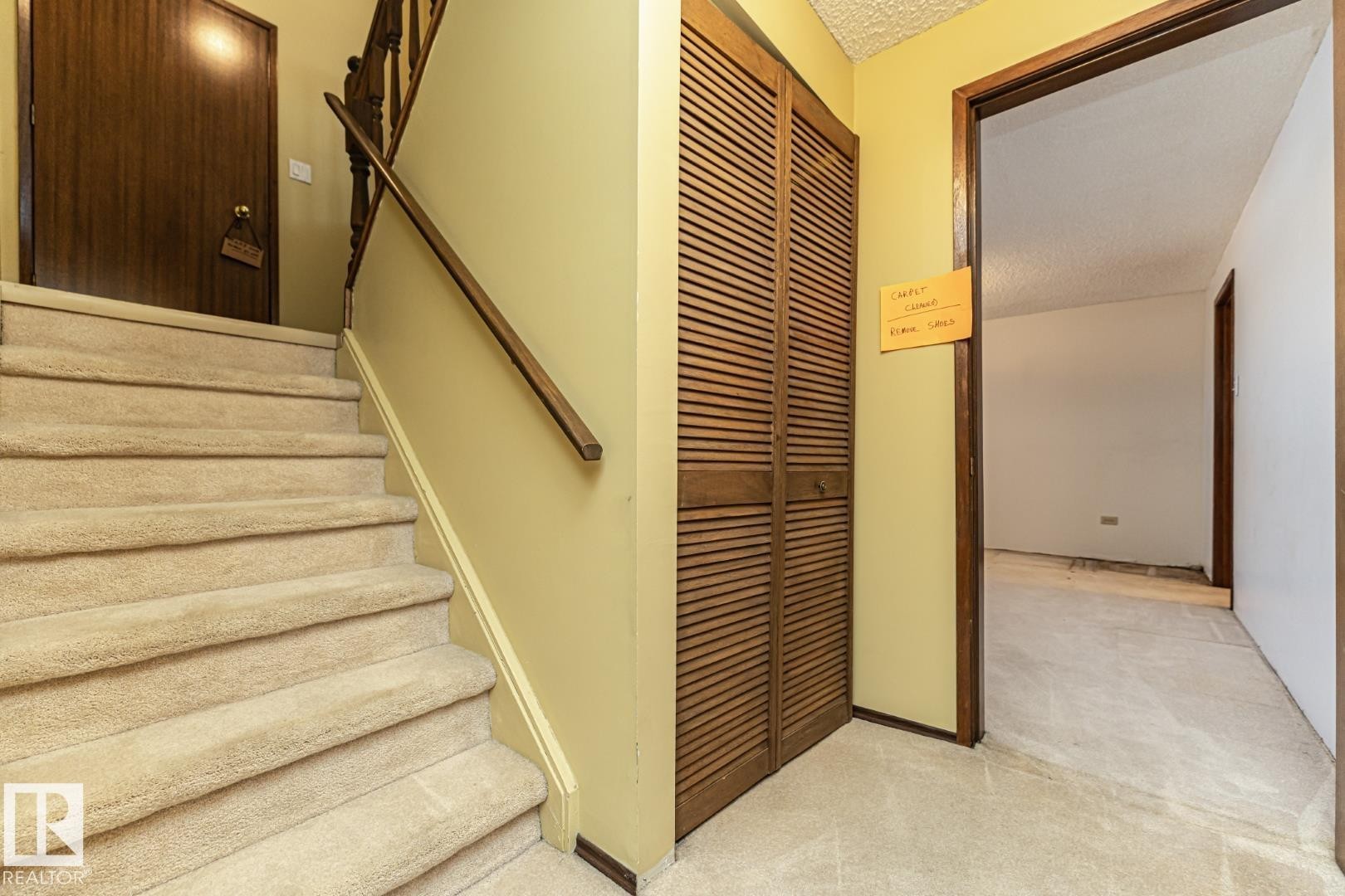 Staircase featuring a textured ceiling and carpet flooring - 10207 165 Avenue, Edmonton, AB - Indoor Photo Showing Other Room