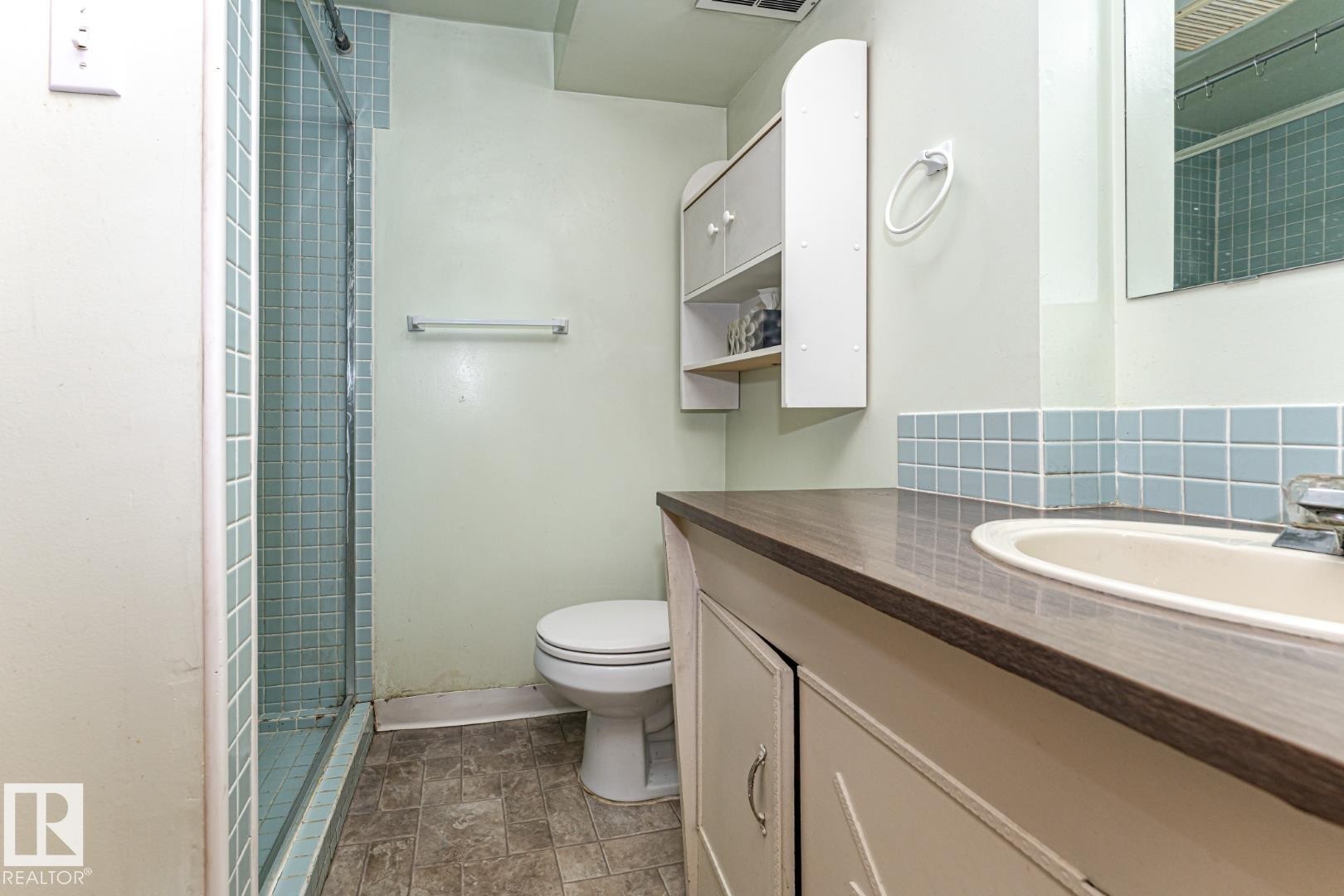 Full bath with a shower stall, vanity, and stone finish floors - 10207 165 Avenue, Edmonton, AB - Indoor Photo Showing Bathroom