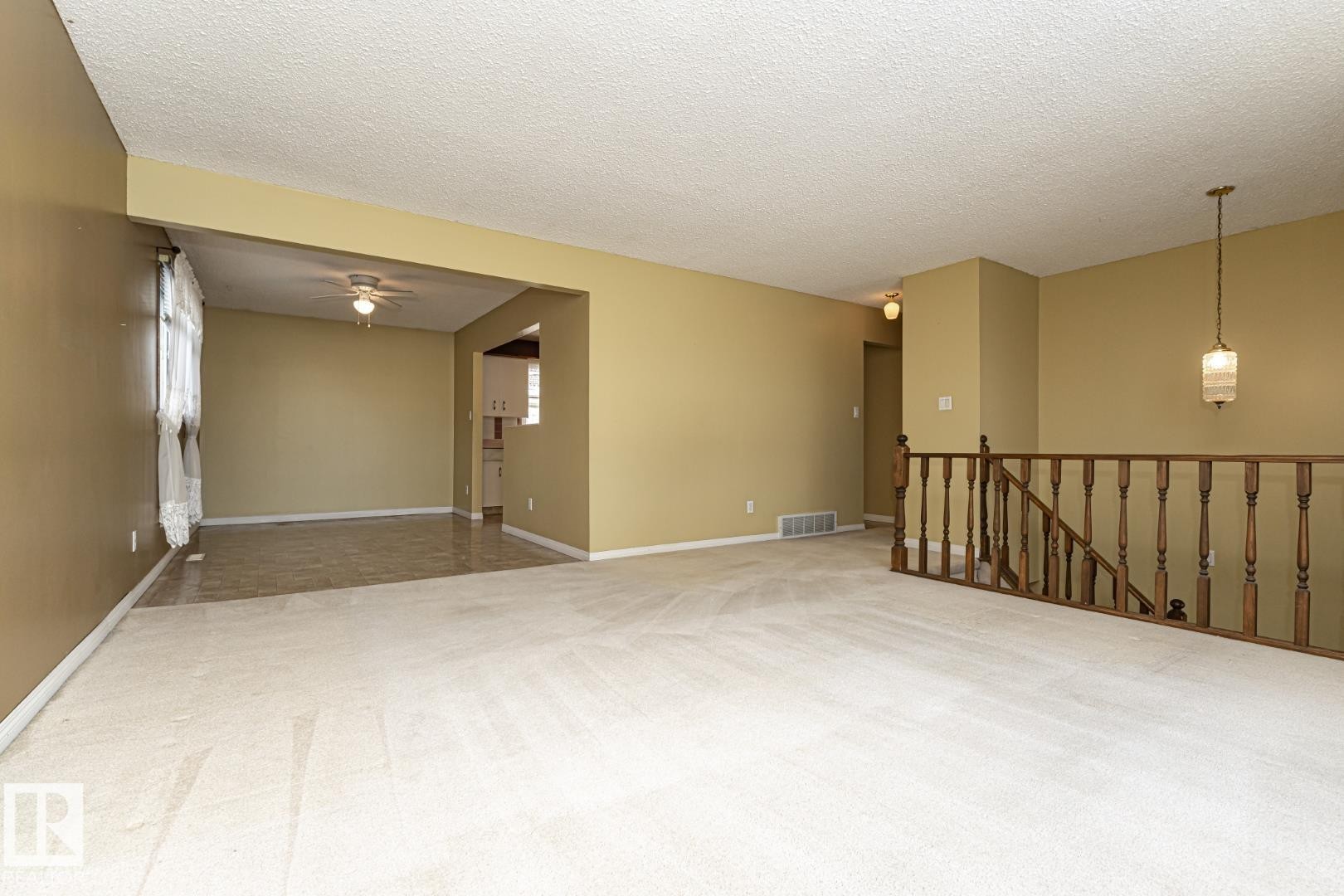Spare room featuring light carpet, a textured ceiling, and ceiling fan - 10207 165 Avenue, Edmonton, AB - Indoor Photo Showing Other Room