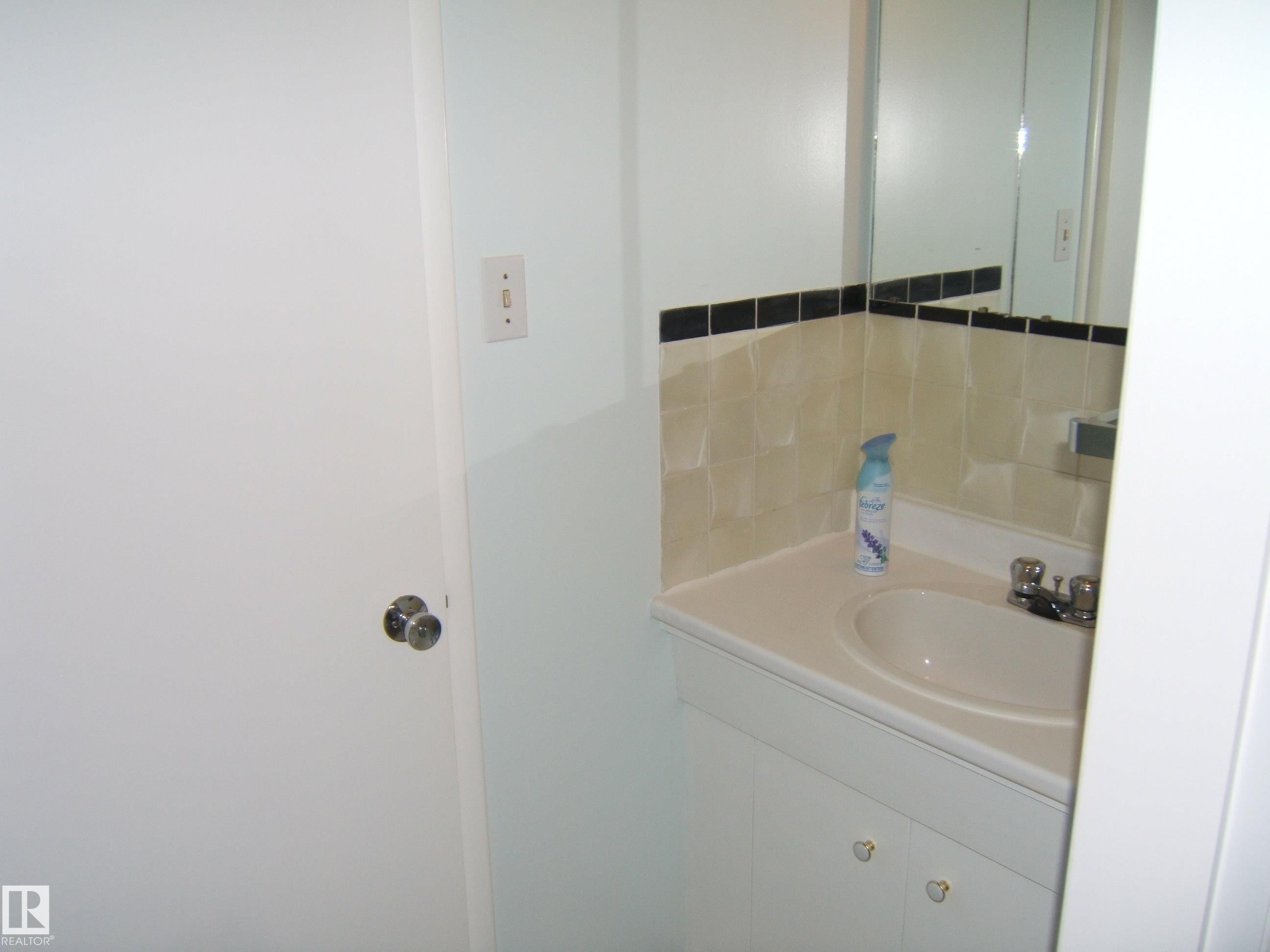 Bathroom with vanity and decorative backsplash - 4910 53 Avenue, Willingdon, AB