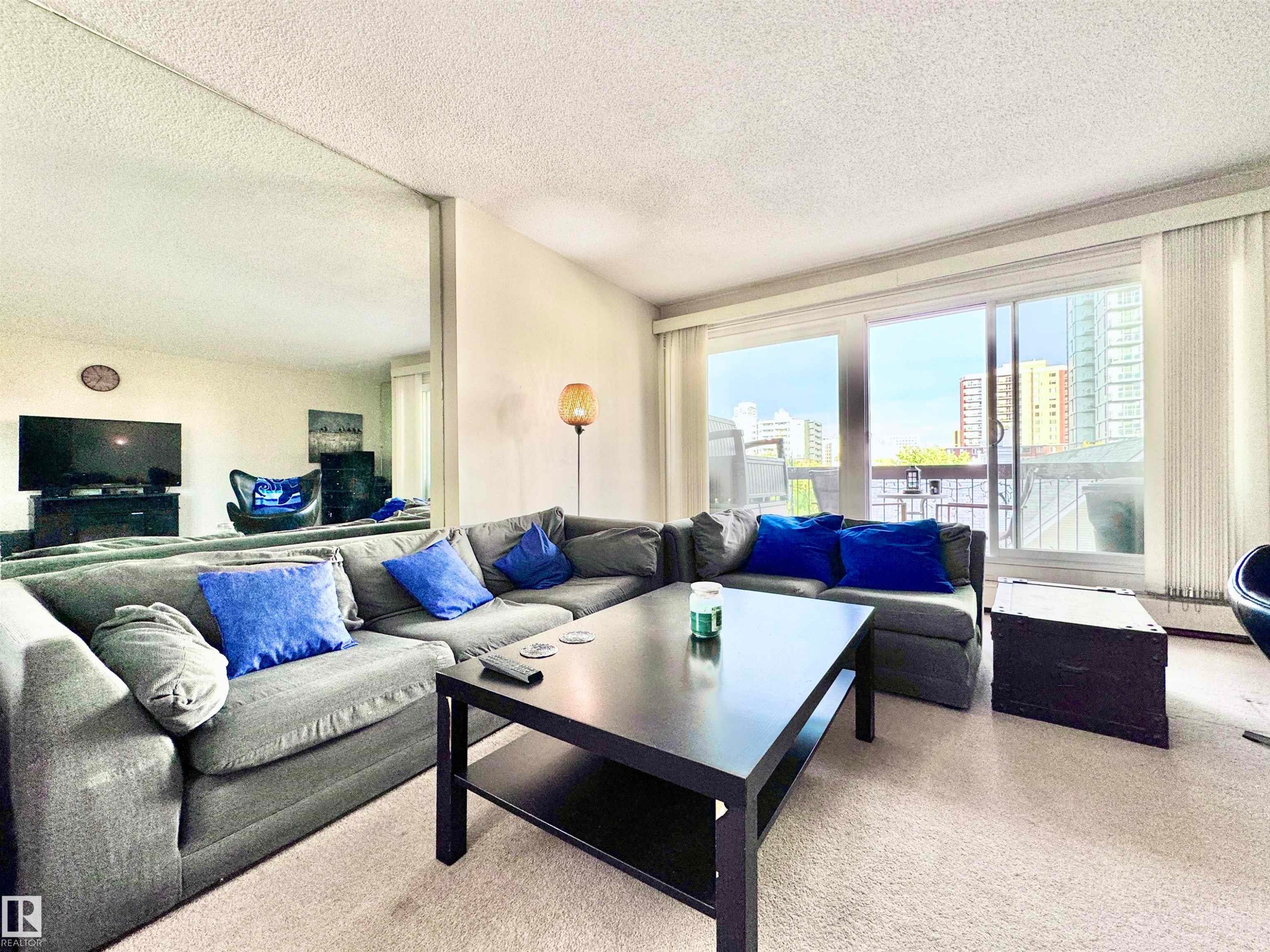 Living area featuring a textured ceiling and carpet flooring - 503 9737 112 Street, Edmonton, AB - Indoor Photo Showing Living Room