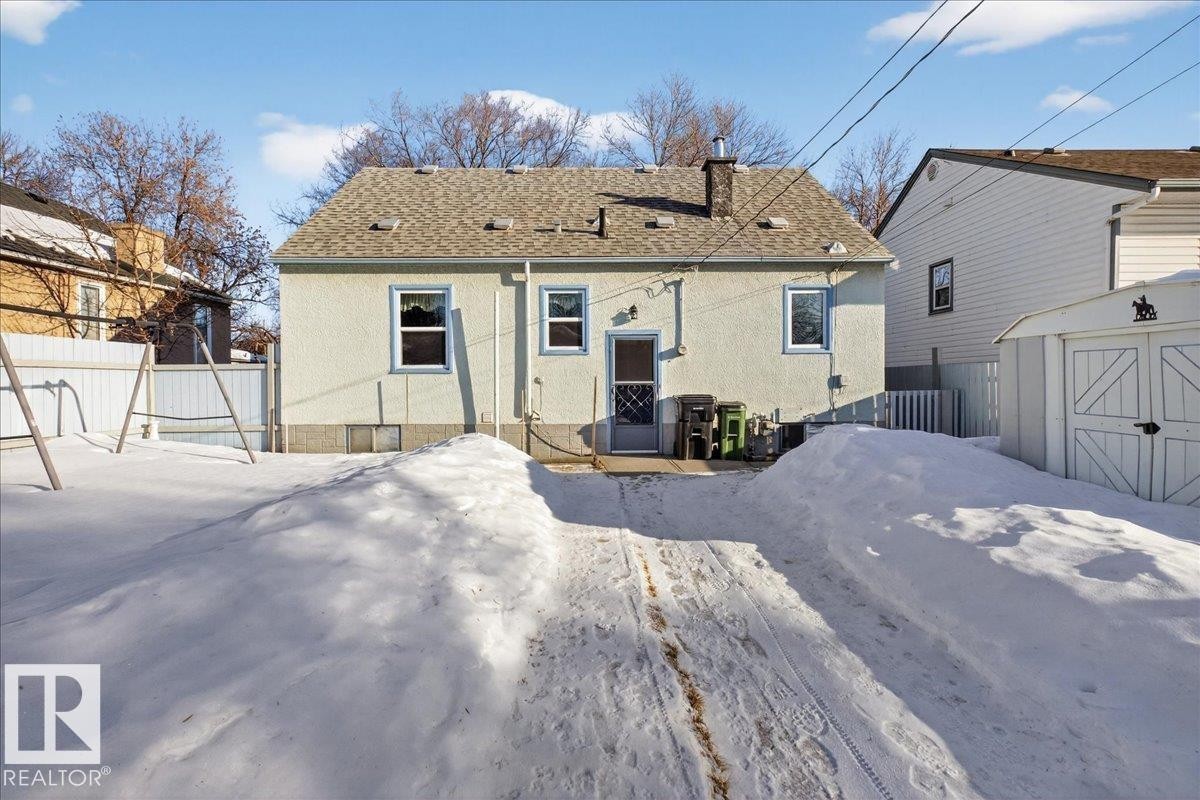 Rear view of property with stucco siding, a chimney, a shingled roof, a shed, and a patio - 11630 71 Street, Edmonton, AB - Outdoor