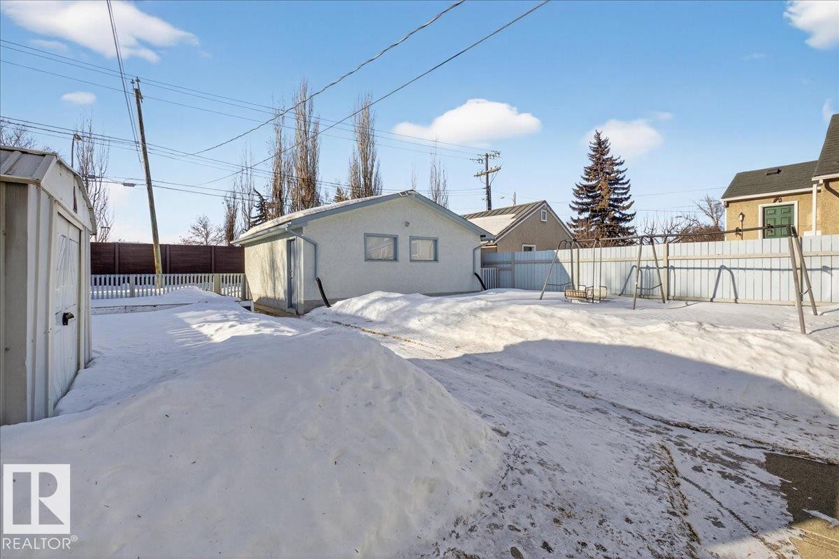 Rear view of property featuring a fenced backyard and an outdoor structure - 11630 71 Street, Edmonton, AB - Outdoor