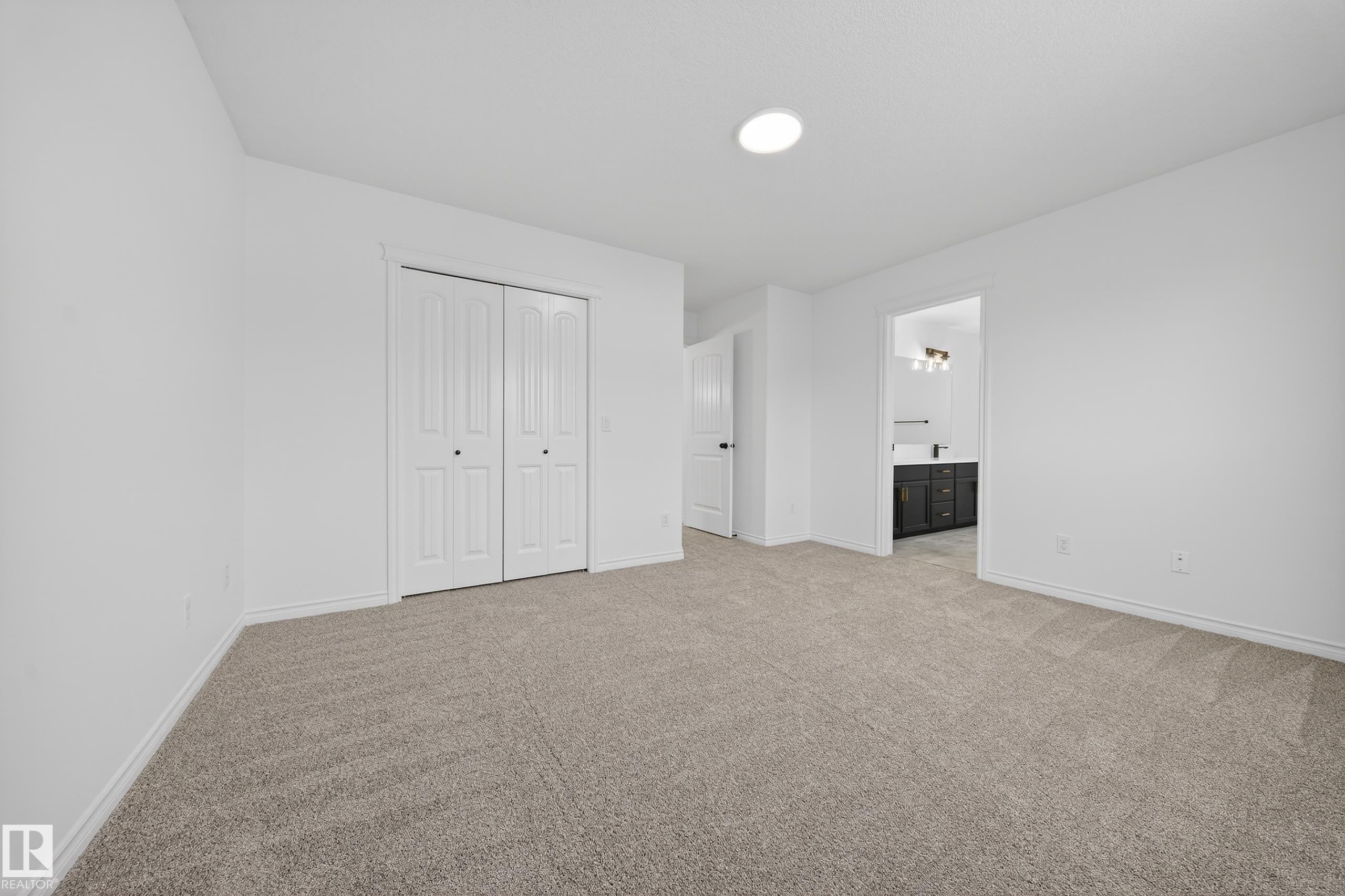 Unfurnished bedroom featuring light colored carpet, a closet, and connected bathroom - 1741 63A Street, Edmonton, AB - Indoor Photo Showing Other Room