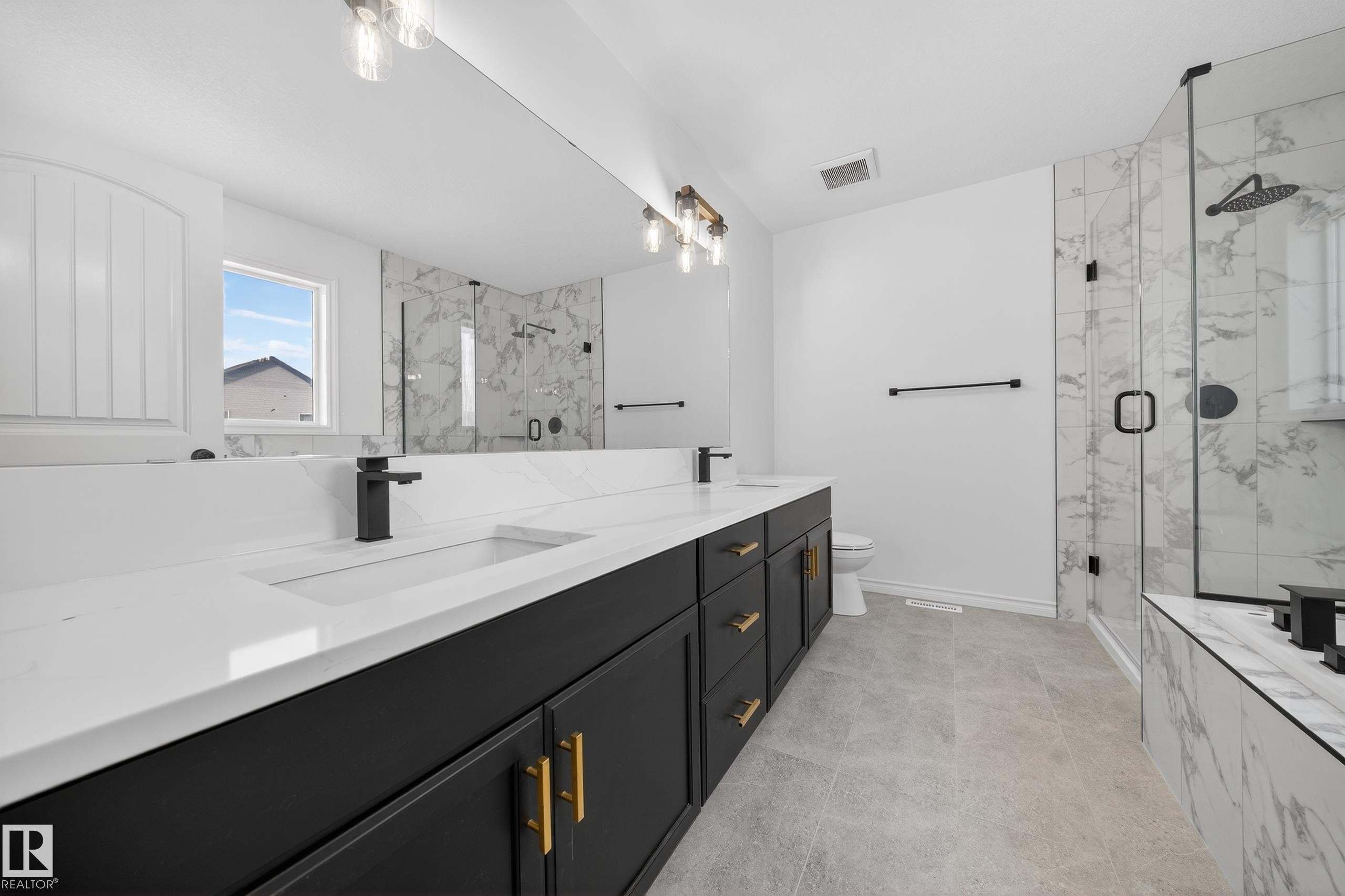 Bathroom featuring a marble finish shower and double vanity - 1741 63A Street, Edmonton, AB - Indoor Photo Showing Bathroom