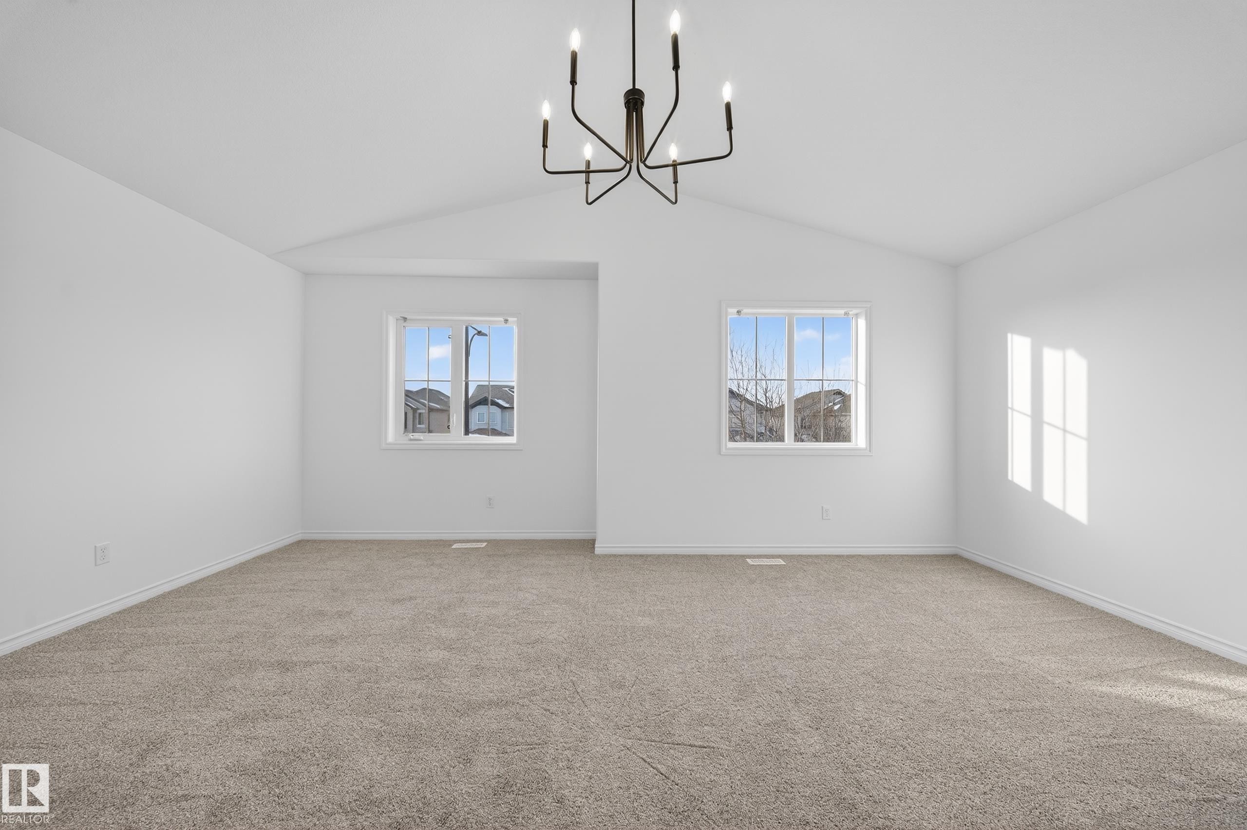 Spare room with light carpet, vaulted ceiling, and a chandelier - 1741 63A Street, Edmonton, AB - Indoor Photo Showing Other Room